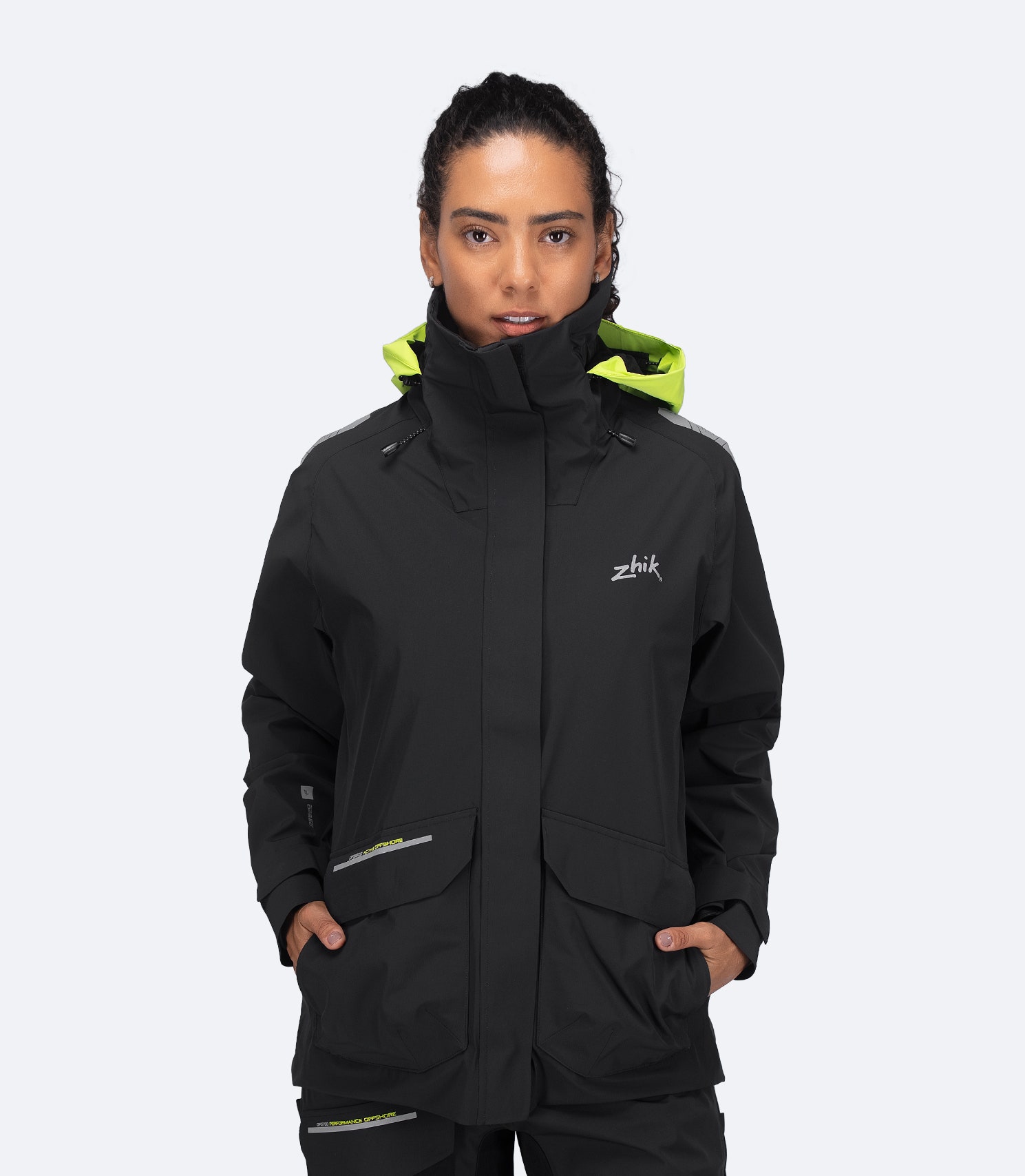 Zhik Women's OFS600 Offshore Sailing Jacket in black, front view with hood down and storm collar up for wind protection.