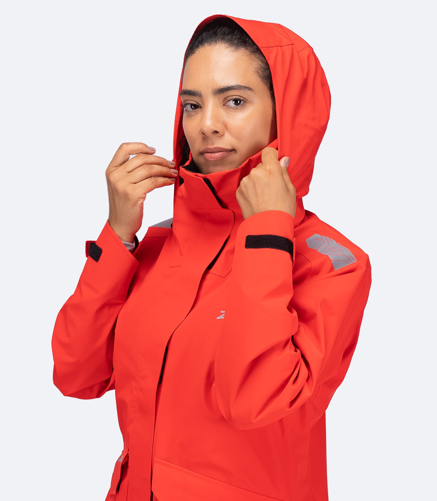 Zhik Women's OFS600 Offshore Jacket in flame red, close-up with hood up and medium-height fleece-lined collar.