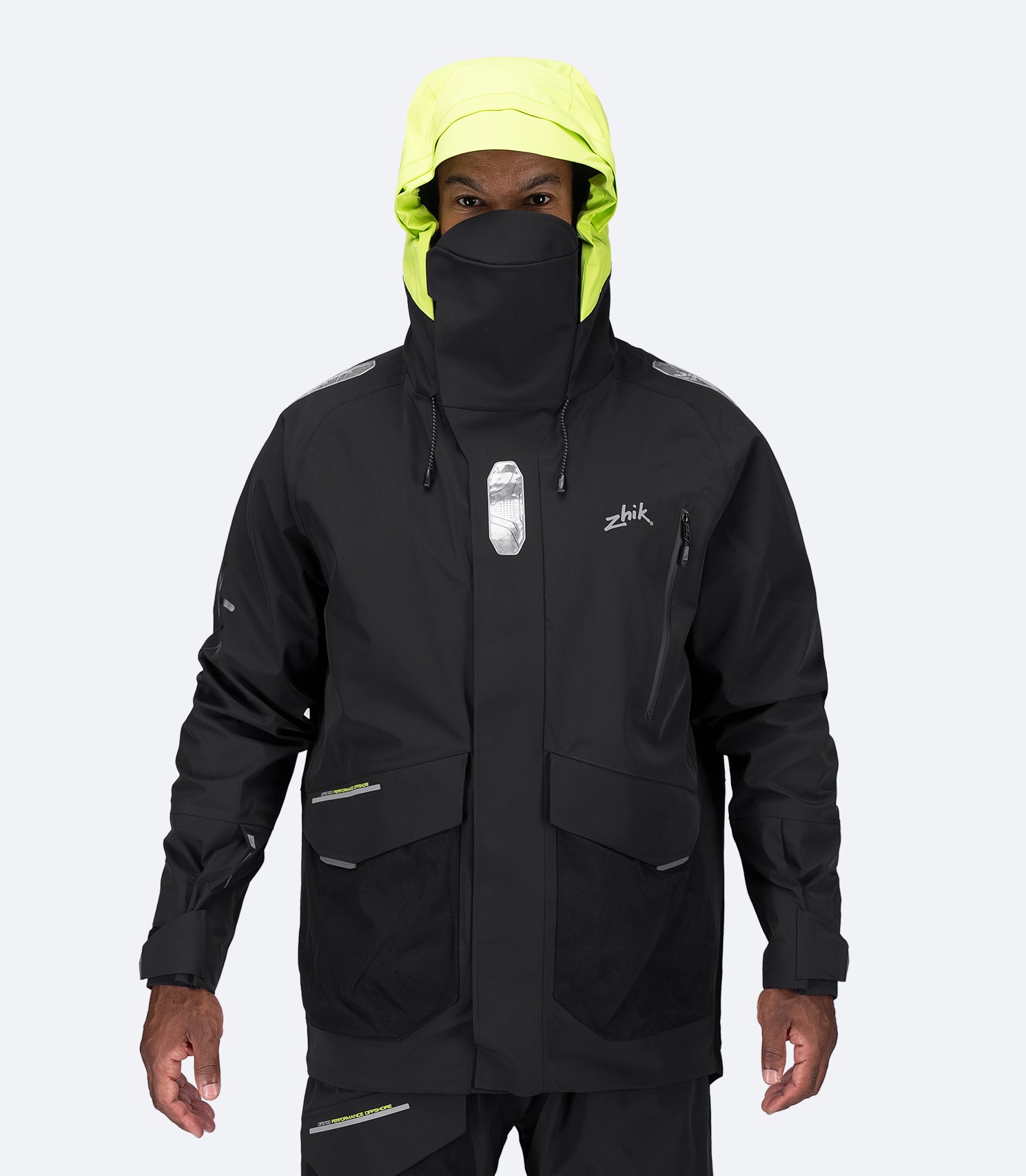 Zhik Men's OFS700 Jacket in black with storm hood on, visor and 3-point adjustment visible.