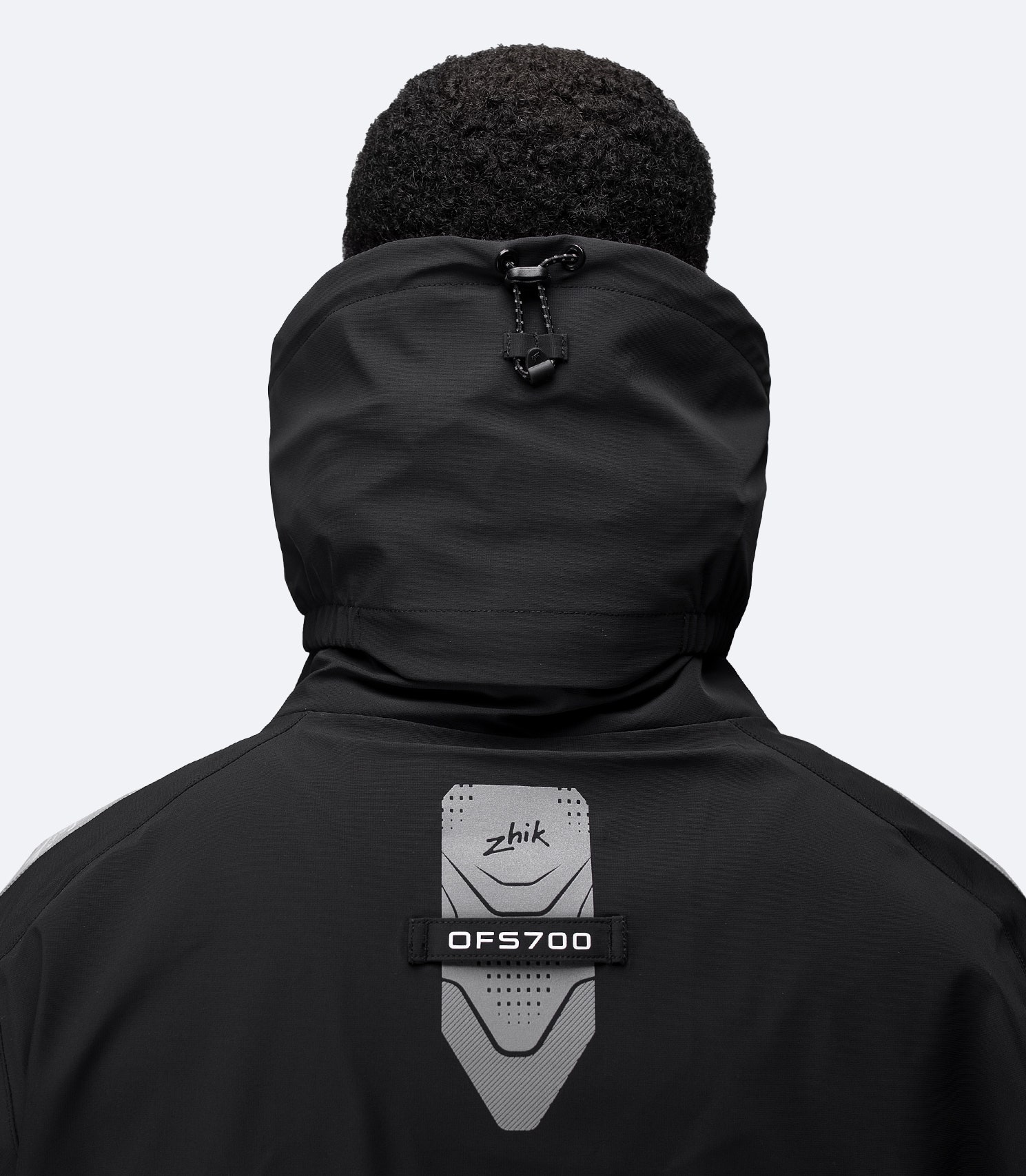 Black OFS700 jacket close-up of rear collar and shoulders with Oralite® reflectors and taped seams.