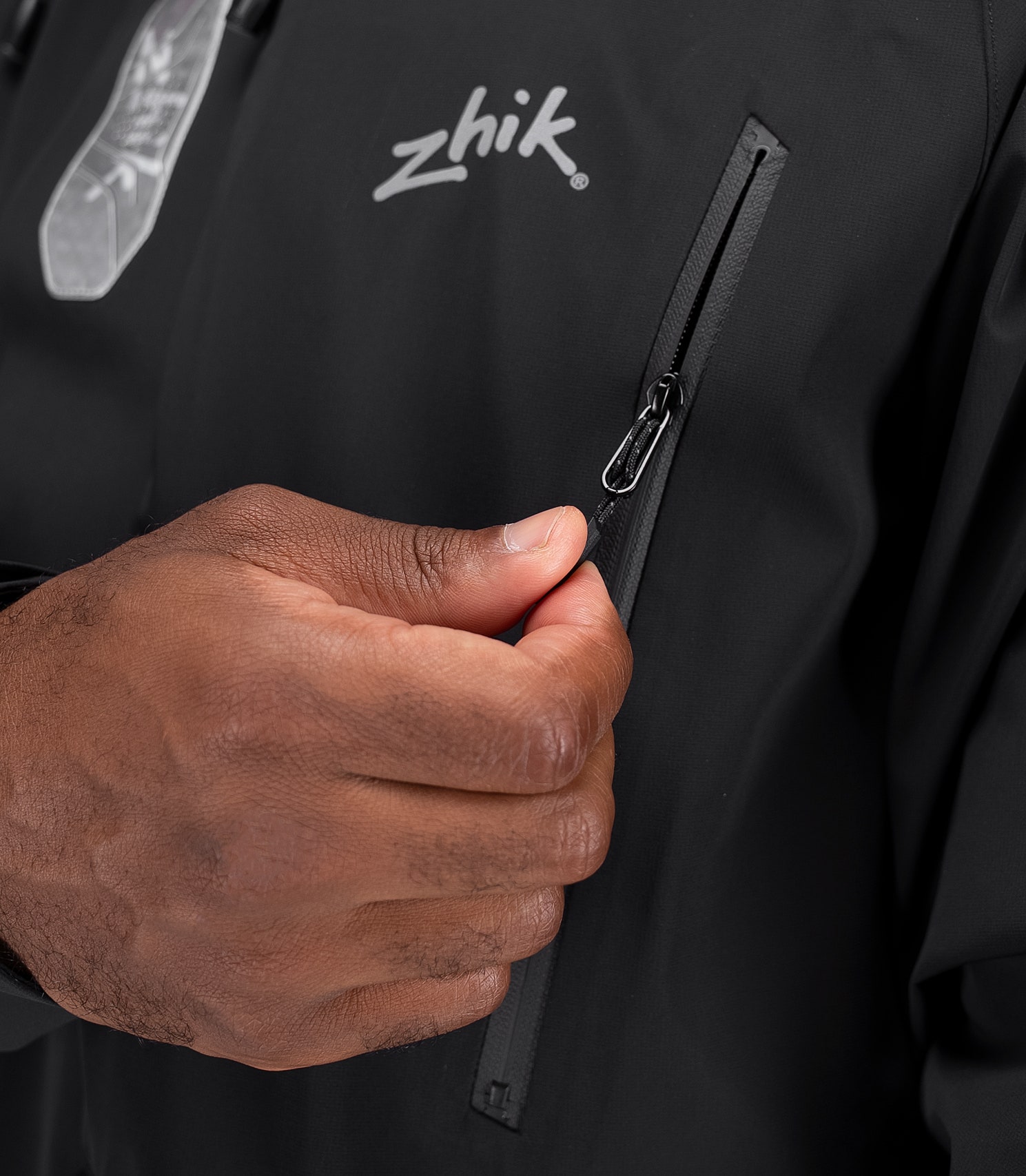 close-up front side pocket on black Zhik OFS700 showing waterproof chest zip pocket.