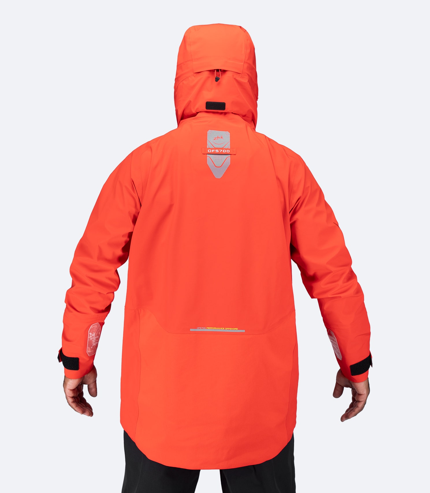 Back of flame red OFS700 Offshore Jacket showing high-cut collar and stowable storm hood.