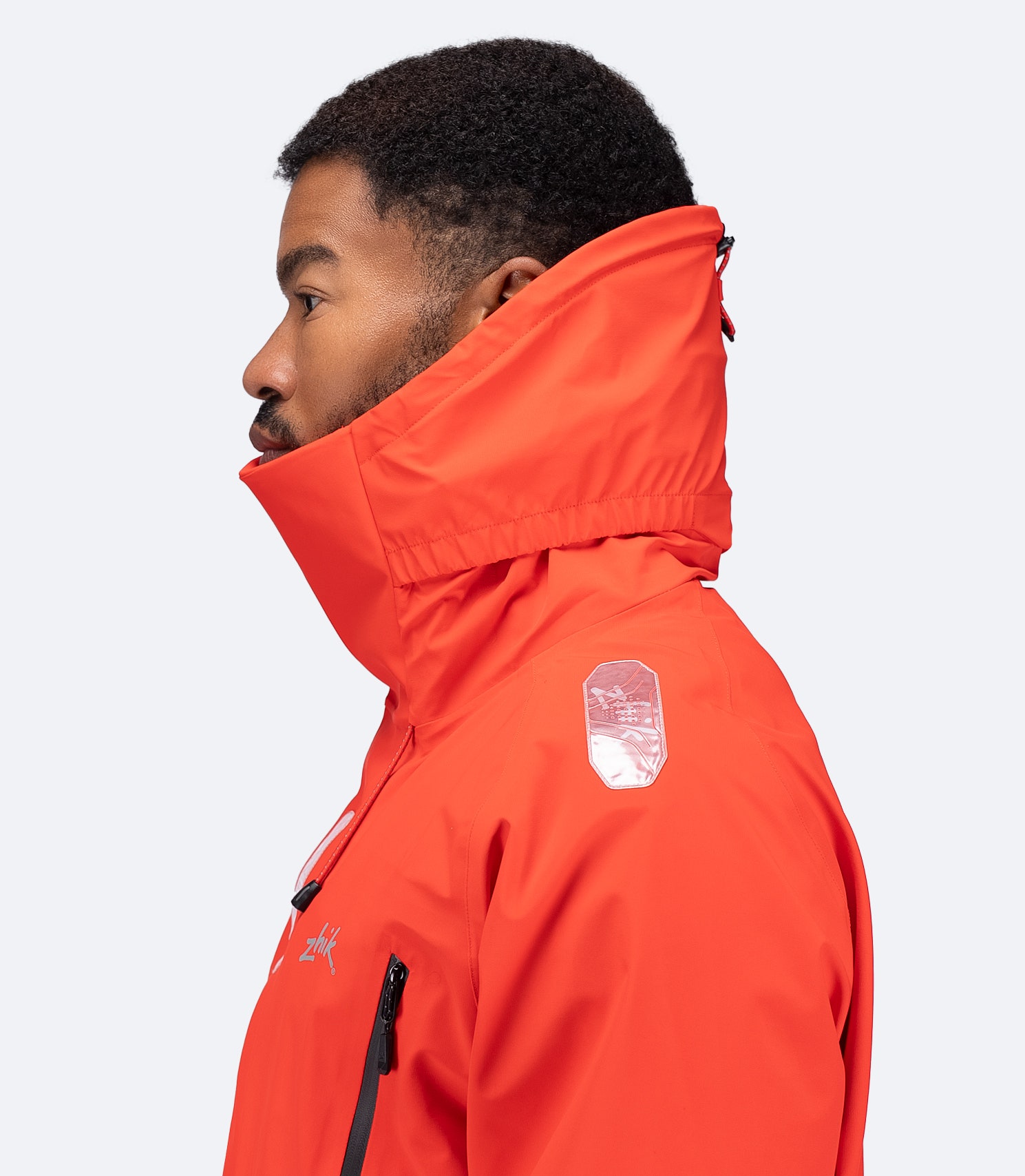 Right shoulder close-up of flame red OFS700 Jacket with reflective detail and collar up.