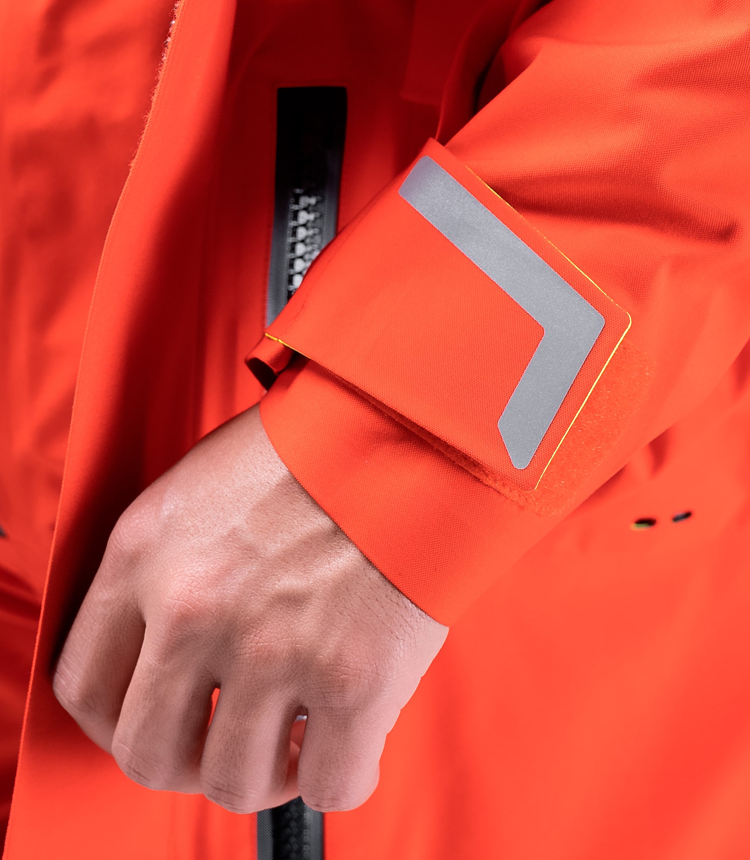 Detail of Advanced Reziseals® on wrists and neck of flame red Zhik Isotak X Jacket, offering super soft and durable composite seals