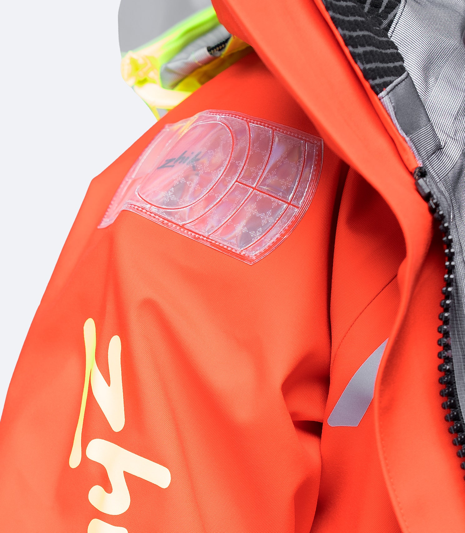 Flame red Zhik Isotak X Jacket with strategically placed Biomotion and Reflexite reflectors for enhanced visibility in low light.