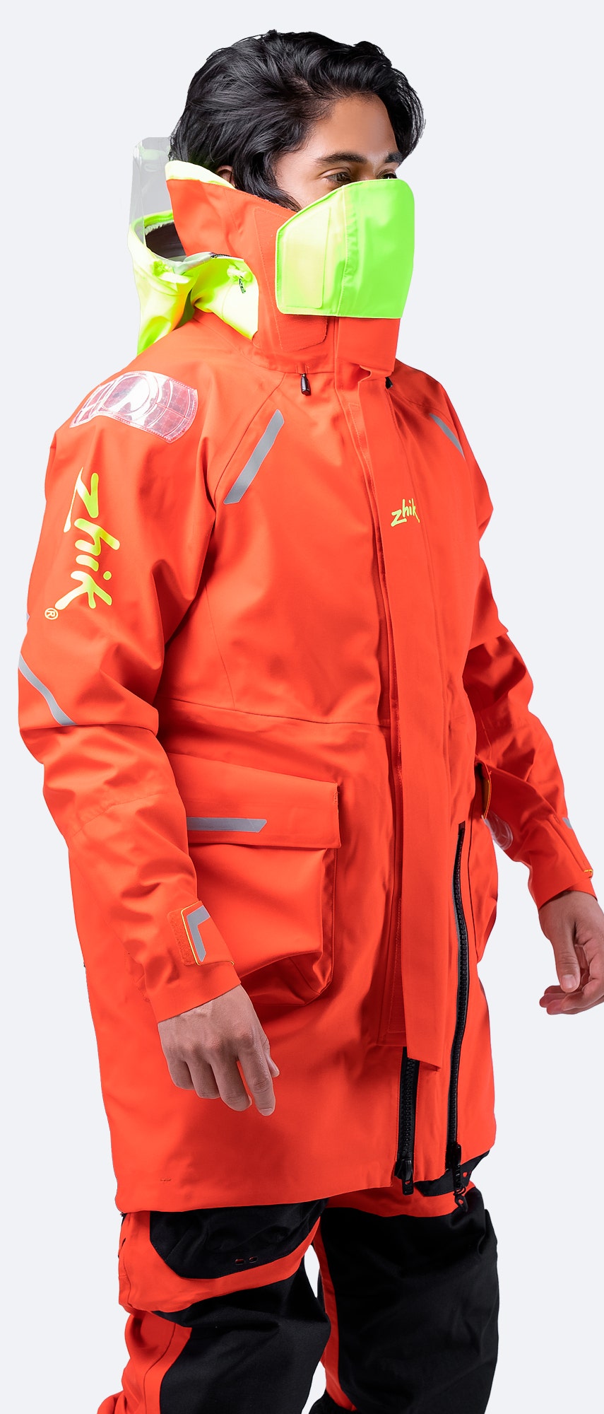 Side profile of Zhik Isotak X Jacket in flame red, highlighting multiple easy-access pockets and Reflexite reflectors for high visibility