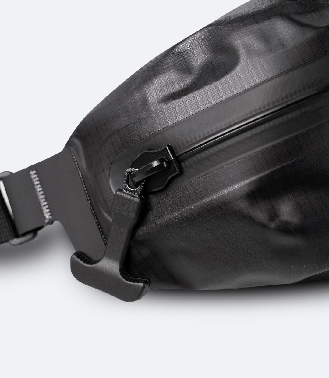 Zhik Waterproof Waist Pack in black, close-up of waterproof zipper and reinforced seam detail.