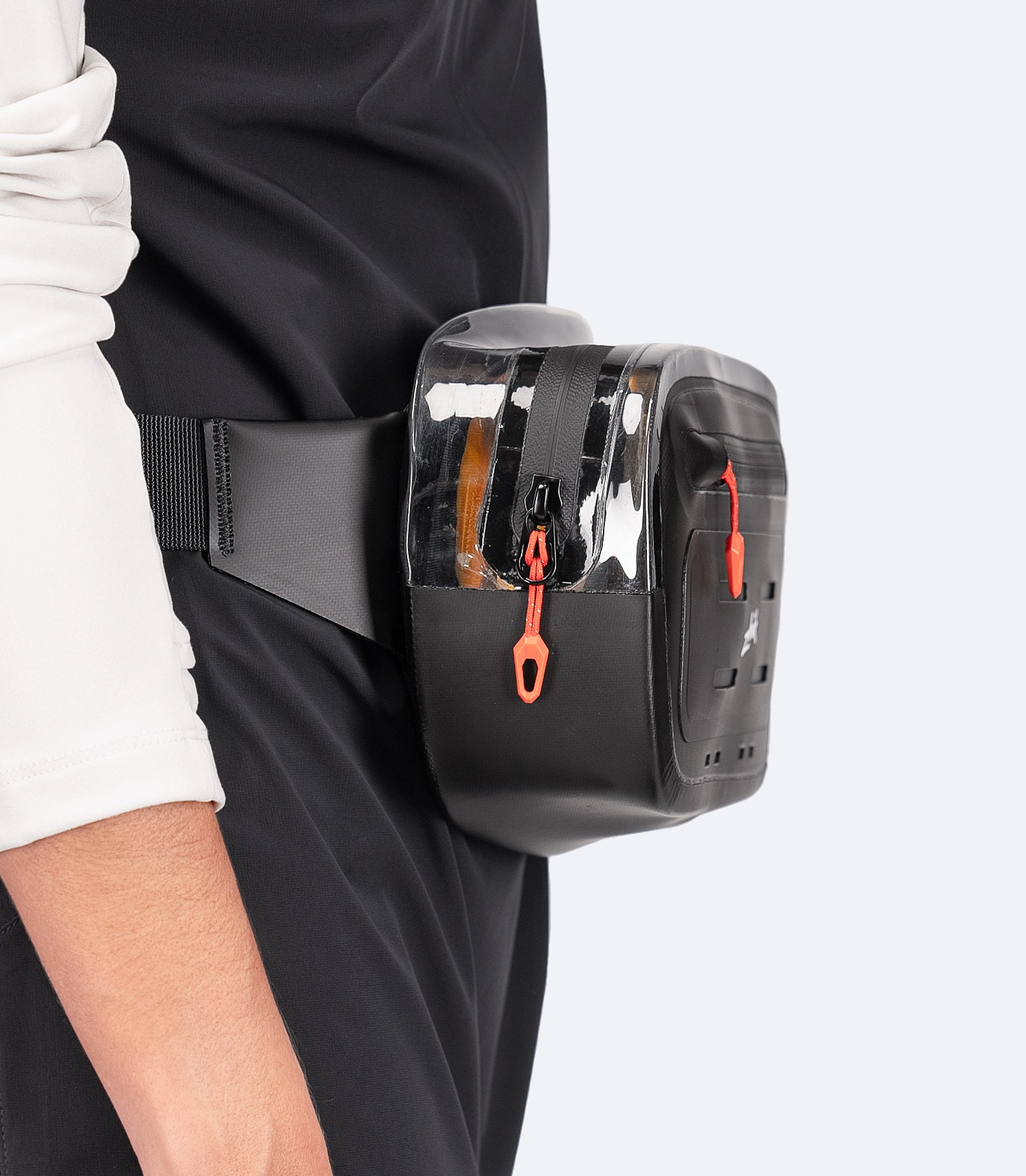 Black Zhik Storm Sling Waist Pack worn at the waist, side view showing breathable mesh back and adjustable 38mm strap with Duraflex® buckle.