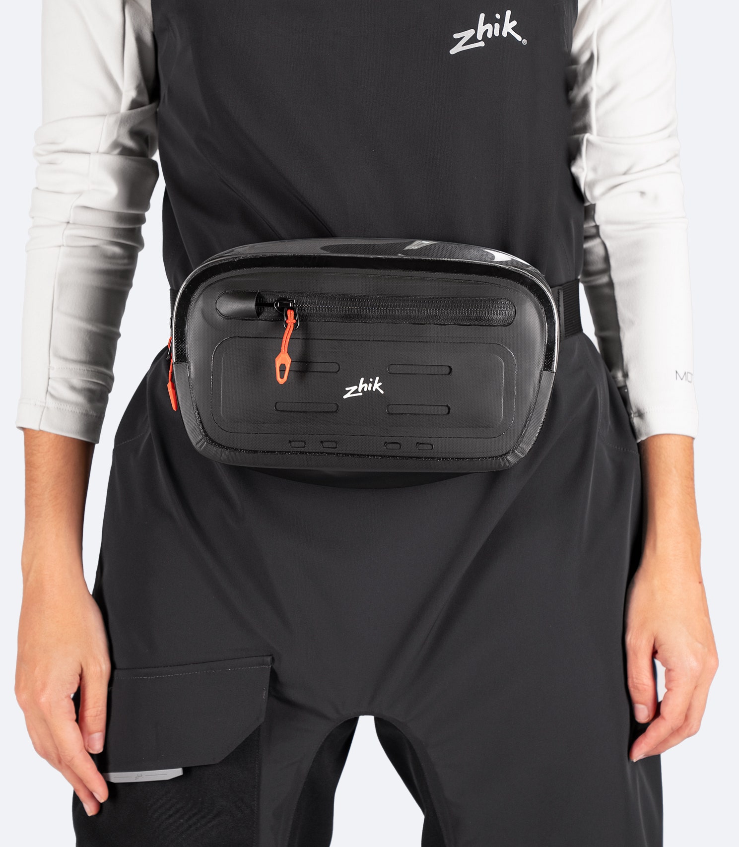 Zhik Storm Sling Waist Pack in black, worn on model, displaying transparent top panel, MOLLE loops, and sleek waterproof construction.