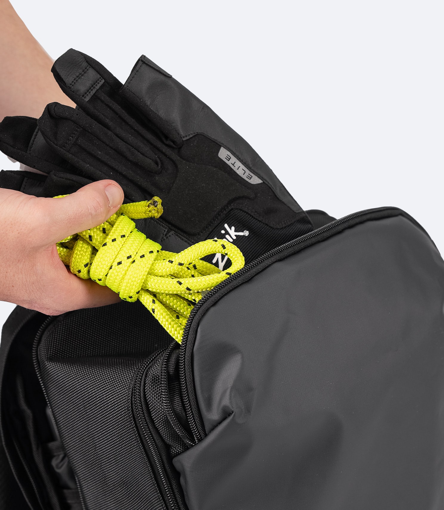 Black Zhik 25L Team Backpack with deep front pocket, ideal for additional storage and easy access to everyday essentials