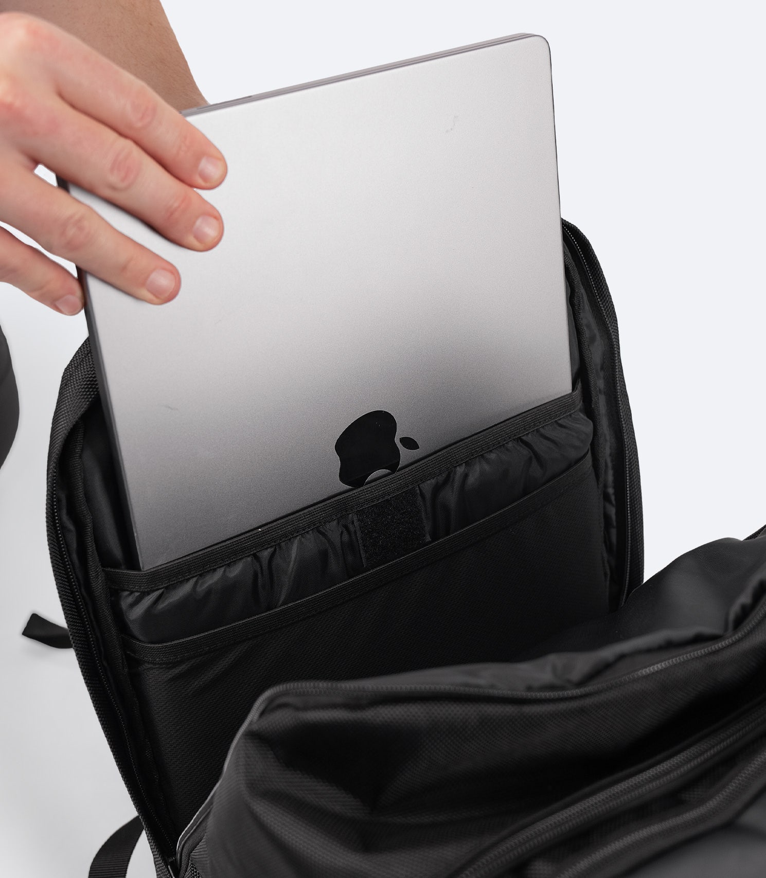 Zhik 25L Team Backpack in black with a padded laptop sleeve inside the zipped back pocket for secure device storage