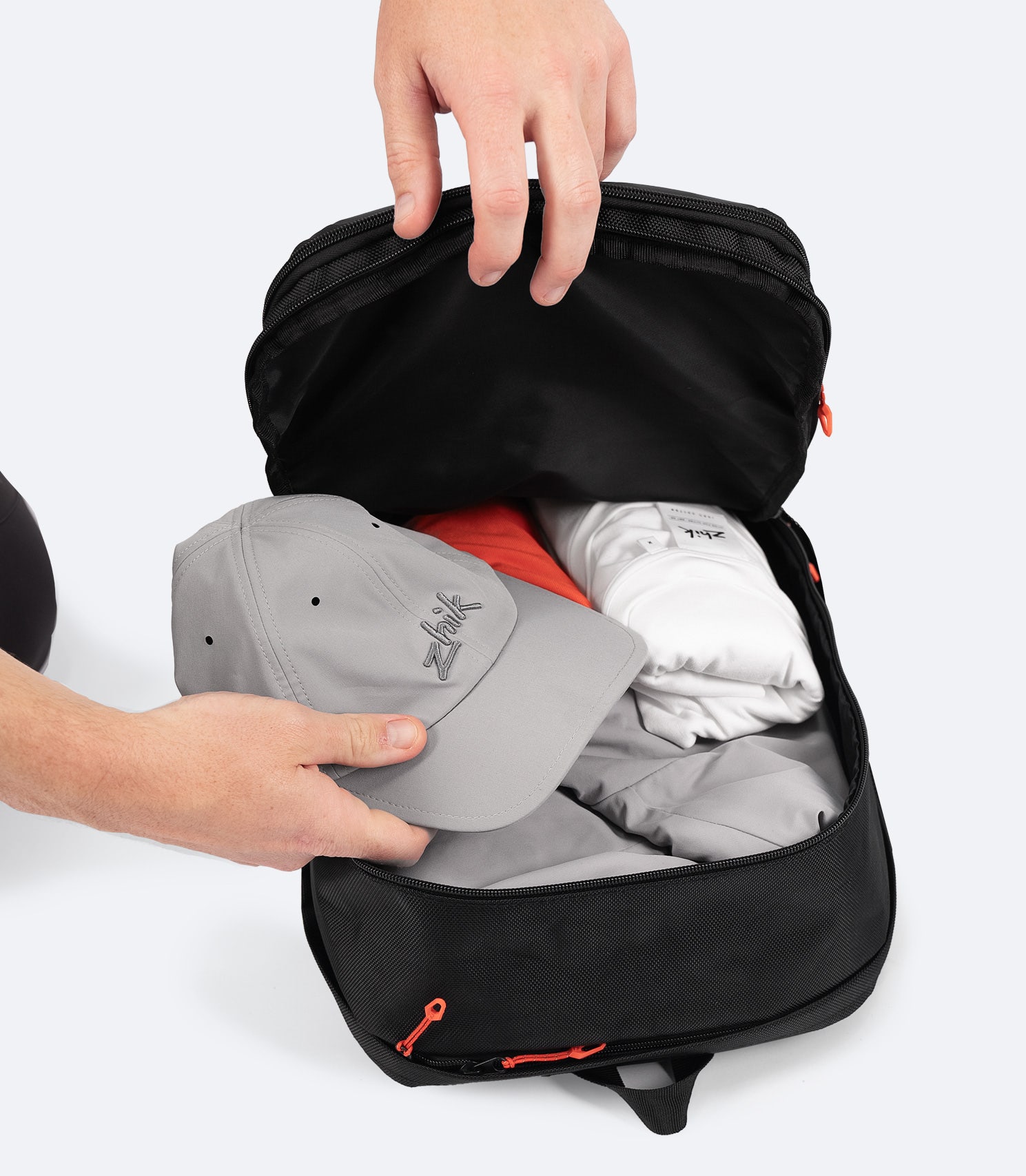 Zhik 25L Team Backpack in black with main compartment open, revealing spacious storage, padded laptop sleeve, and mesh pocket for organization.