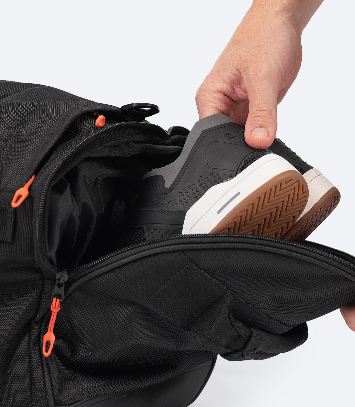 Close-up of the Zhik 55L Duffel Bag’s side pocket in black, featuring a ventilated wet gear compartment for separating damp items