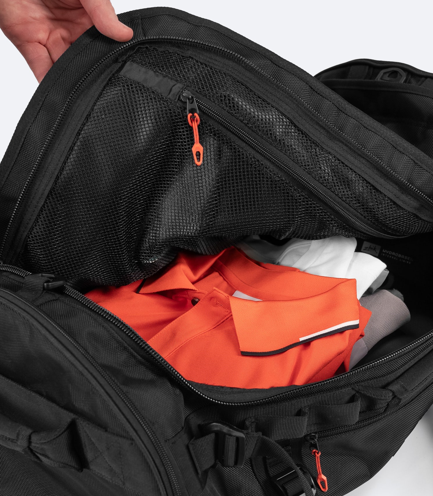 Zhik 55L Duffel Bag main compartment open, showing internal separation mesh and zip pocket for organizing gear and valuables