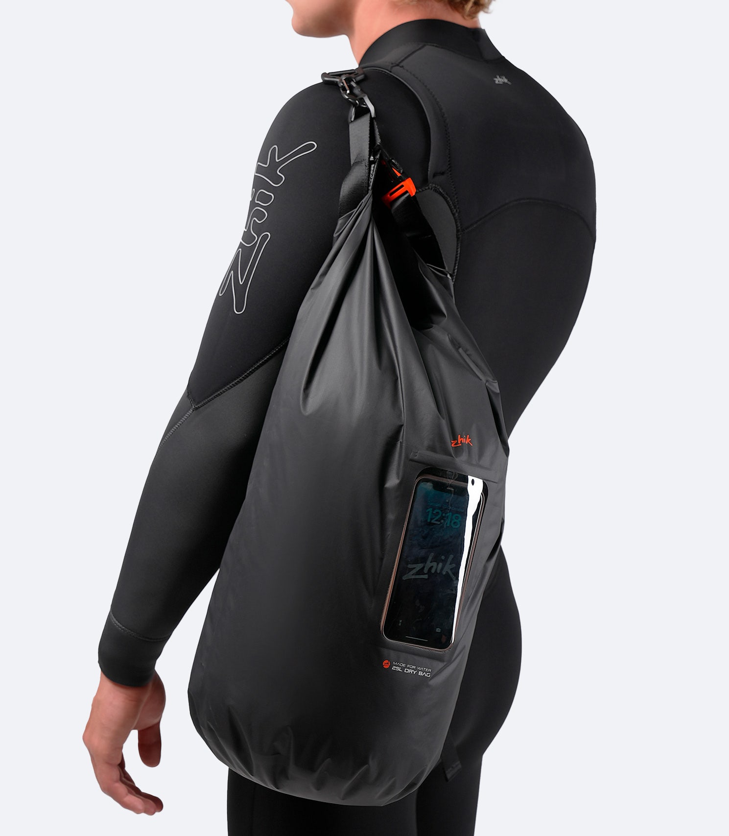 Zhik 25L Dry Bag carried over the shoulder, showcasing lightweight build and modular strap design.