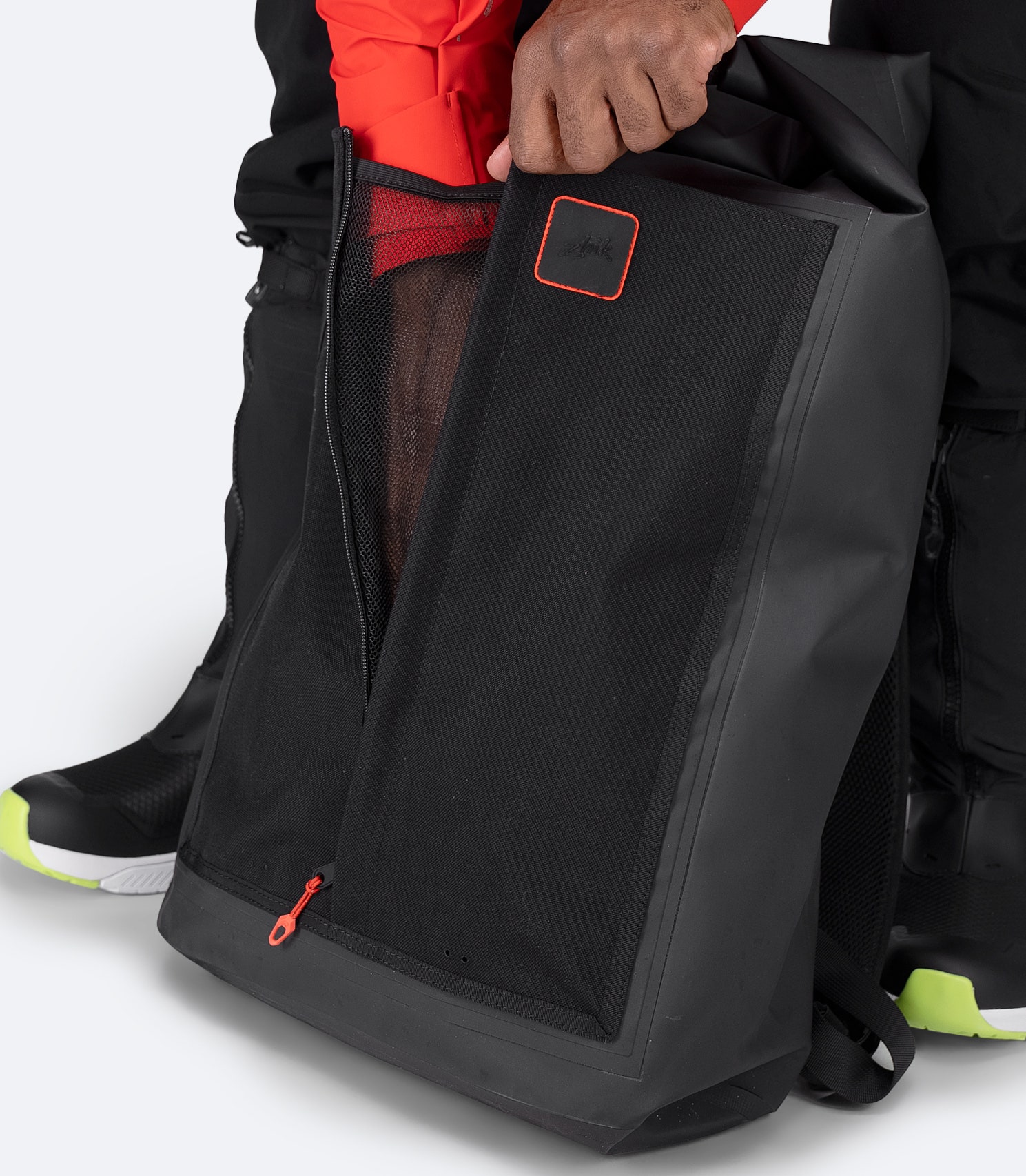 Zhik 35L Waterproof Backpack in black with front utility pocket unzipped, ideal for wet or quick-access items.