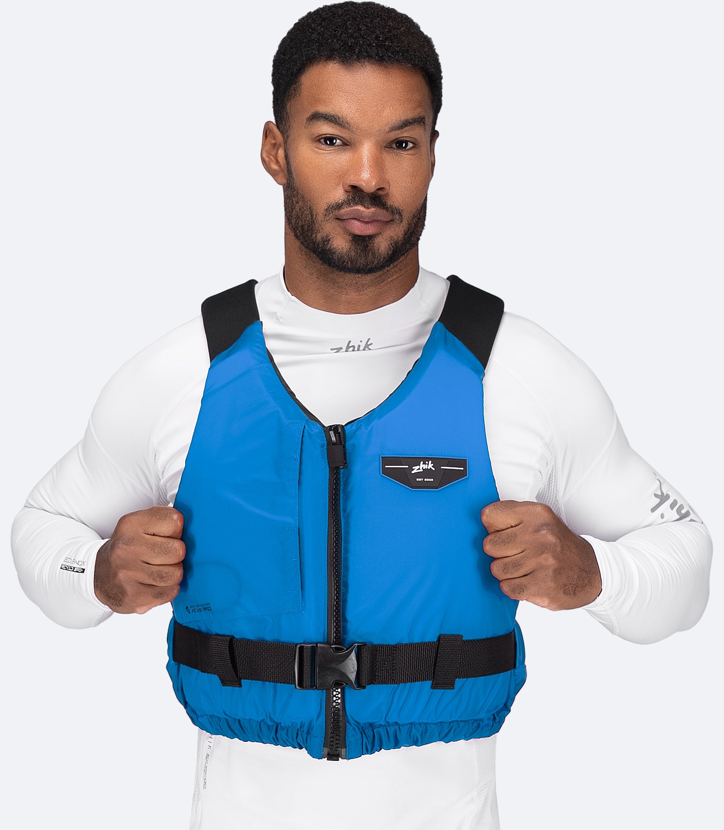 Model wearing Zhik USCG Approved Active PFD in cyan, front view