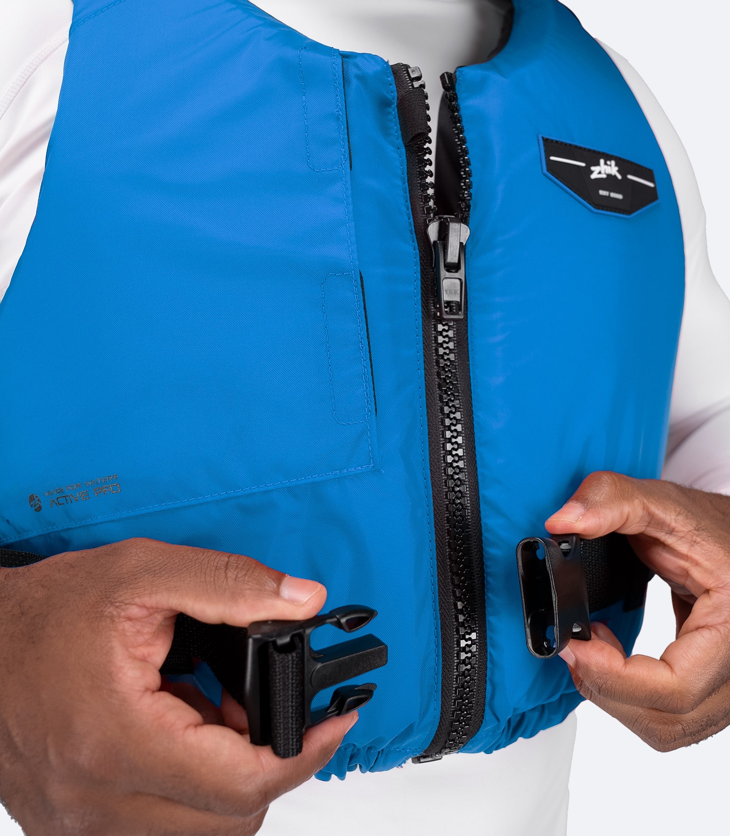 Close-up of zipper and fastening detail on Zhik USCG Approved Active PFD in cyan