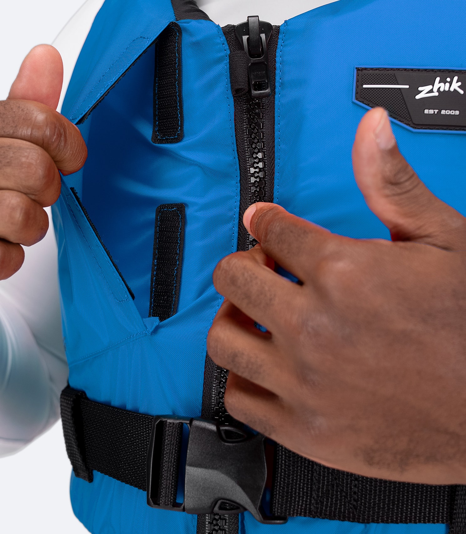Close-up of buckle adjustment on Zhik USCG Approved Active PFD in cyan
