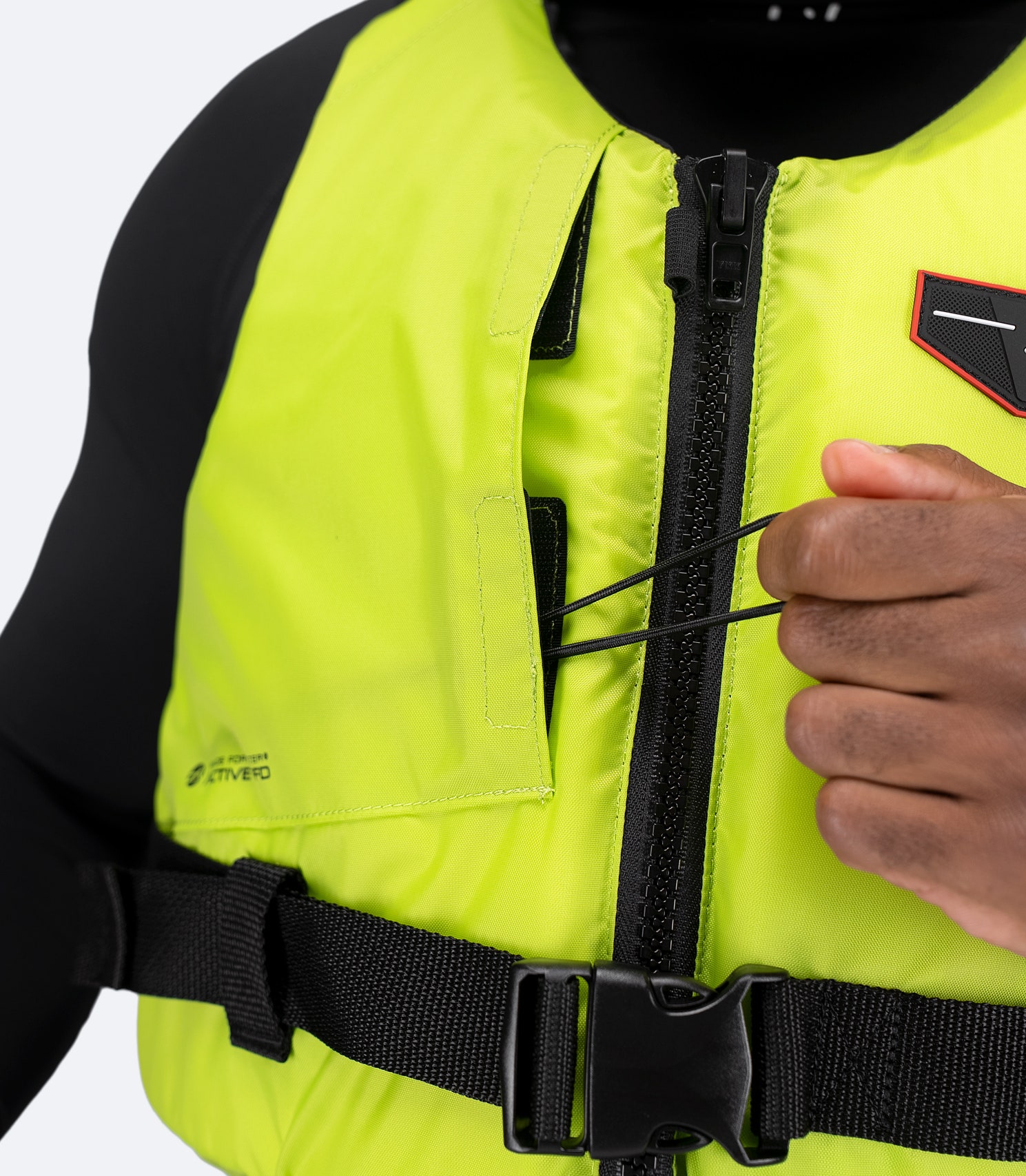 Detail of lime green Zhik Active PFD chest pocket with drainage for storing small essentials securely.