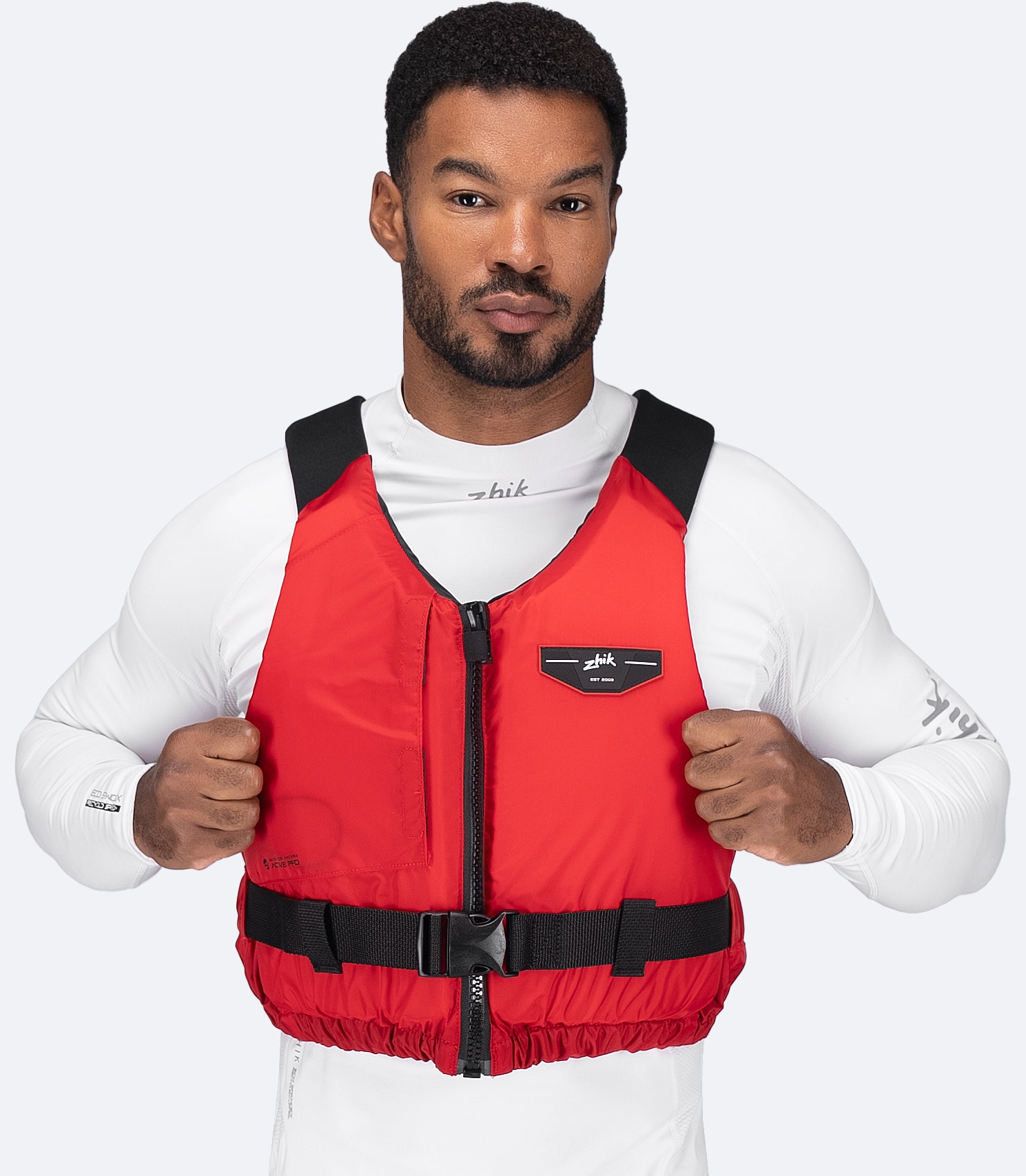 Model wearing Zhik USCG Approved Active PFD in red, front view
