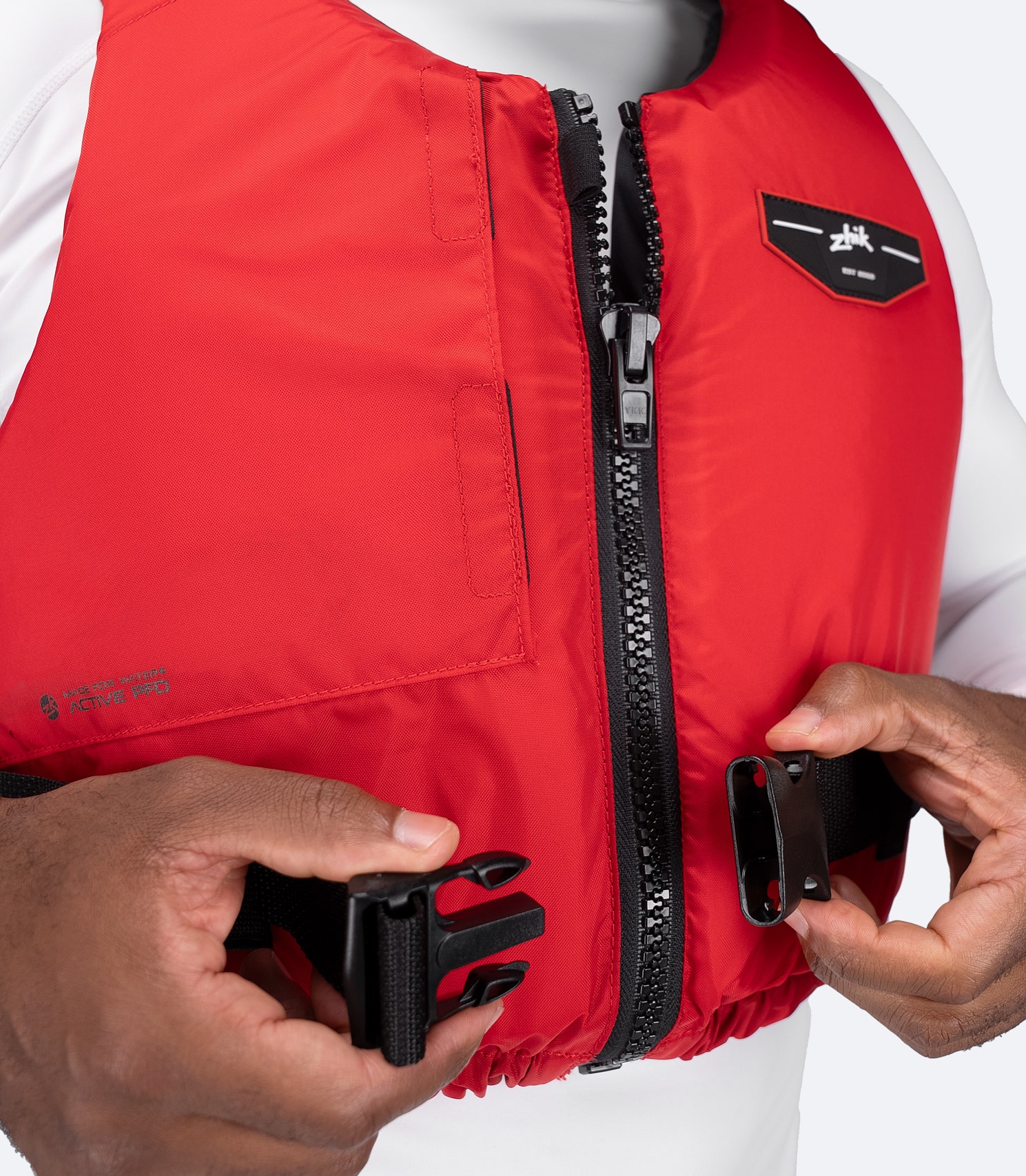 Close-up of buckle adjustment on Zhik USCG Approved Active PFD in red