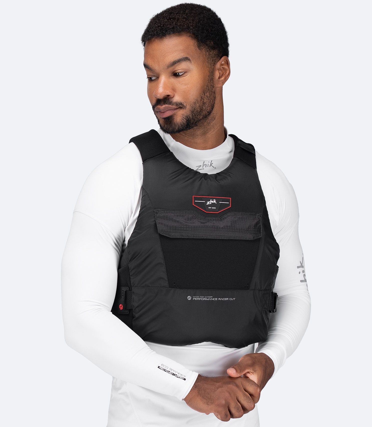 Model wearing Zhik USCG Approved Performance Racecut PFD in black, front view