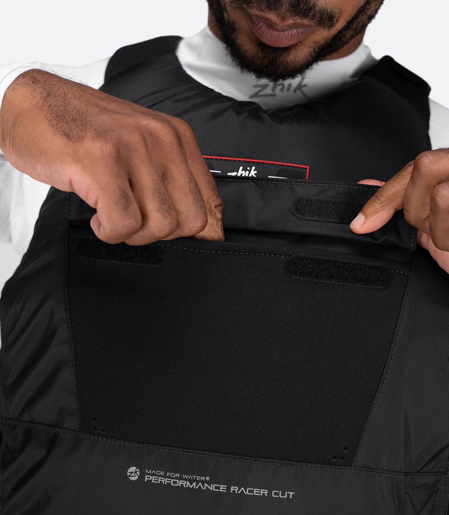 Close-up of large front pocket on Zhik USCG Approved Performance Racecut PFD in black
