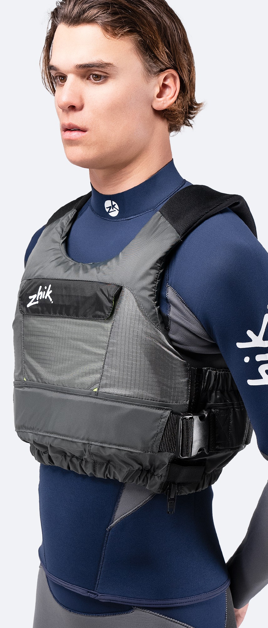 Zhik P3 PFD in grey, side view showing streamlined design, flexible neoprene shoulders, and a fast-entry side zipper.