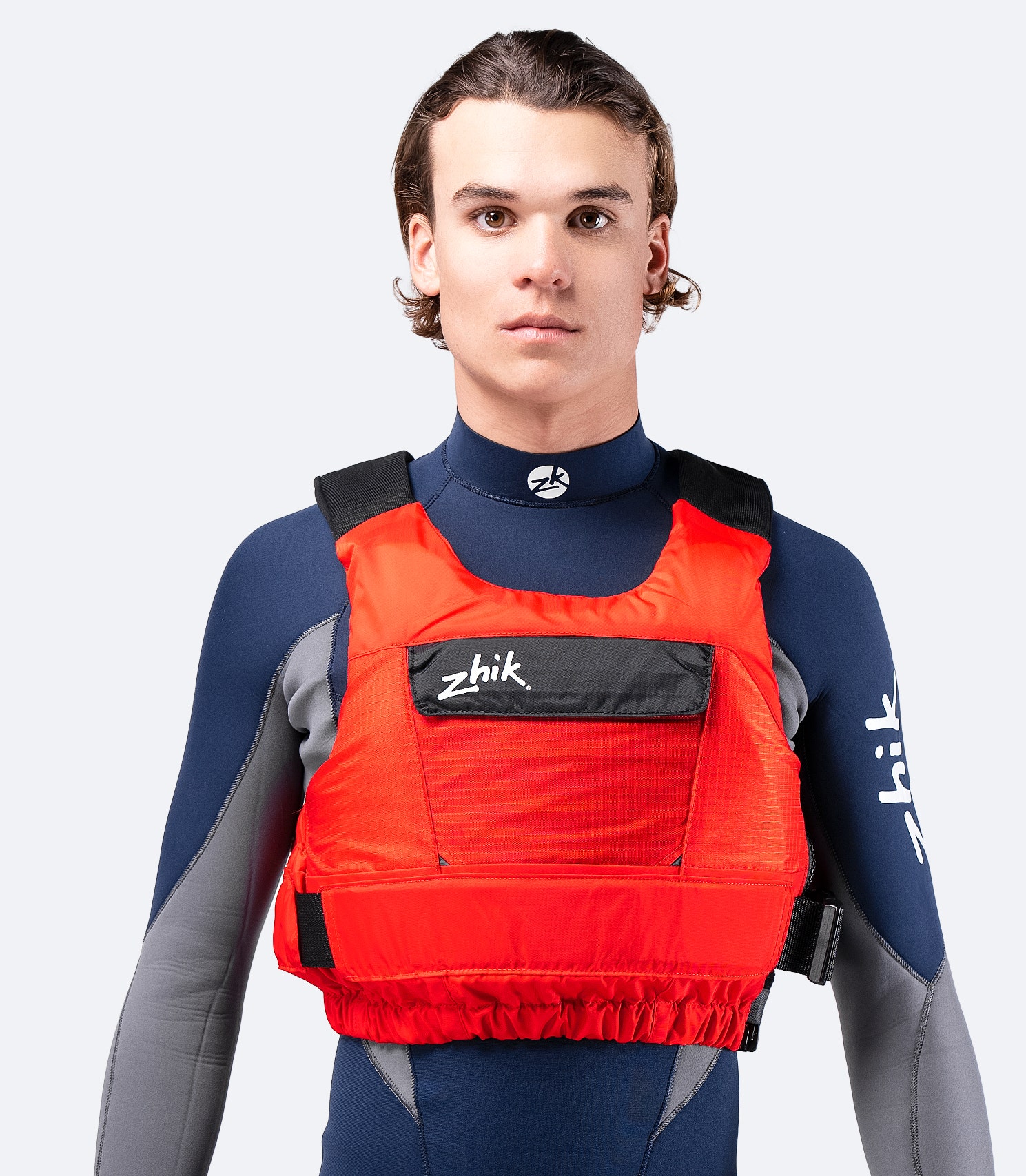 Zhik P3 PFD in red, front angle showing ISO-certified buoyancy aid with a smooth, ergonomic fit and adjustable waist strap.