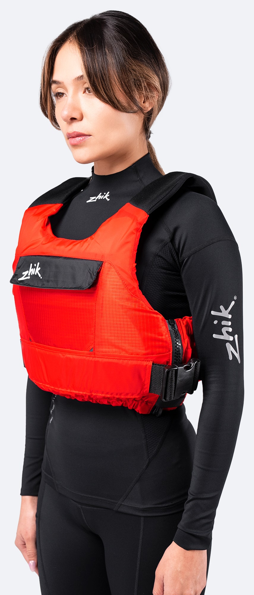 Zhik P3 PFD in red, side angle revealing smooth, low-profile fit with an easy-access side zipper and ergonomic cut.