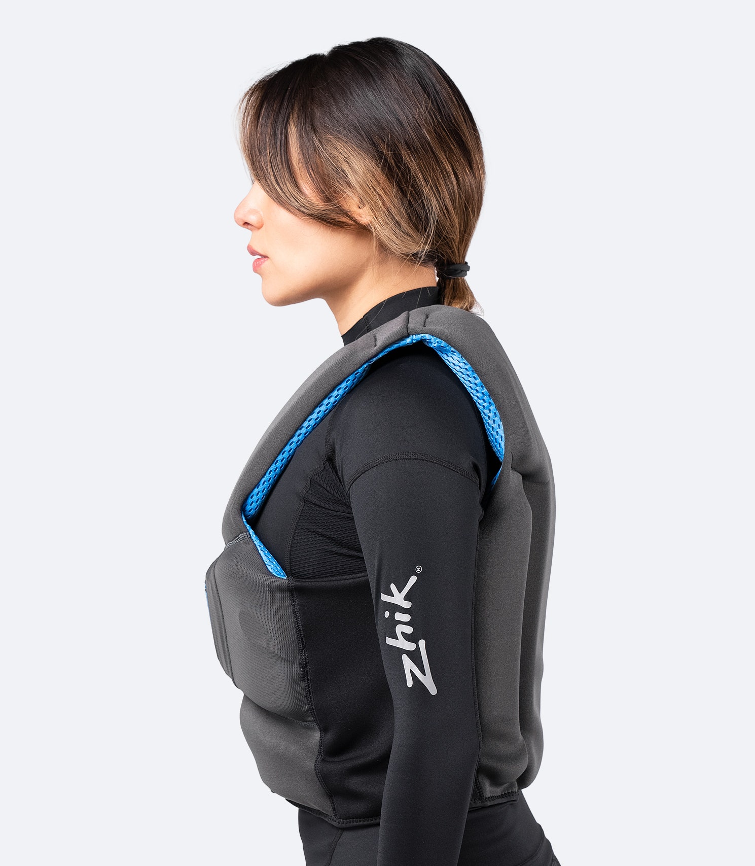 Side view of Zhik P2 PFD in grey, showing body-contoured fit, side zipper entry, and breathable mesh panels.