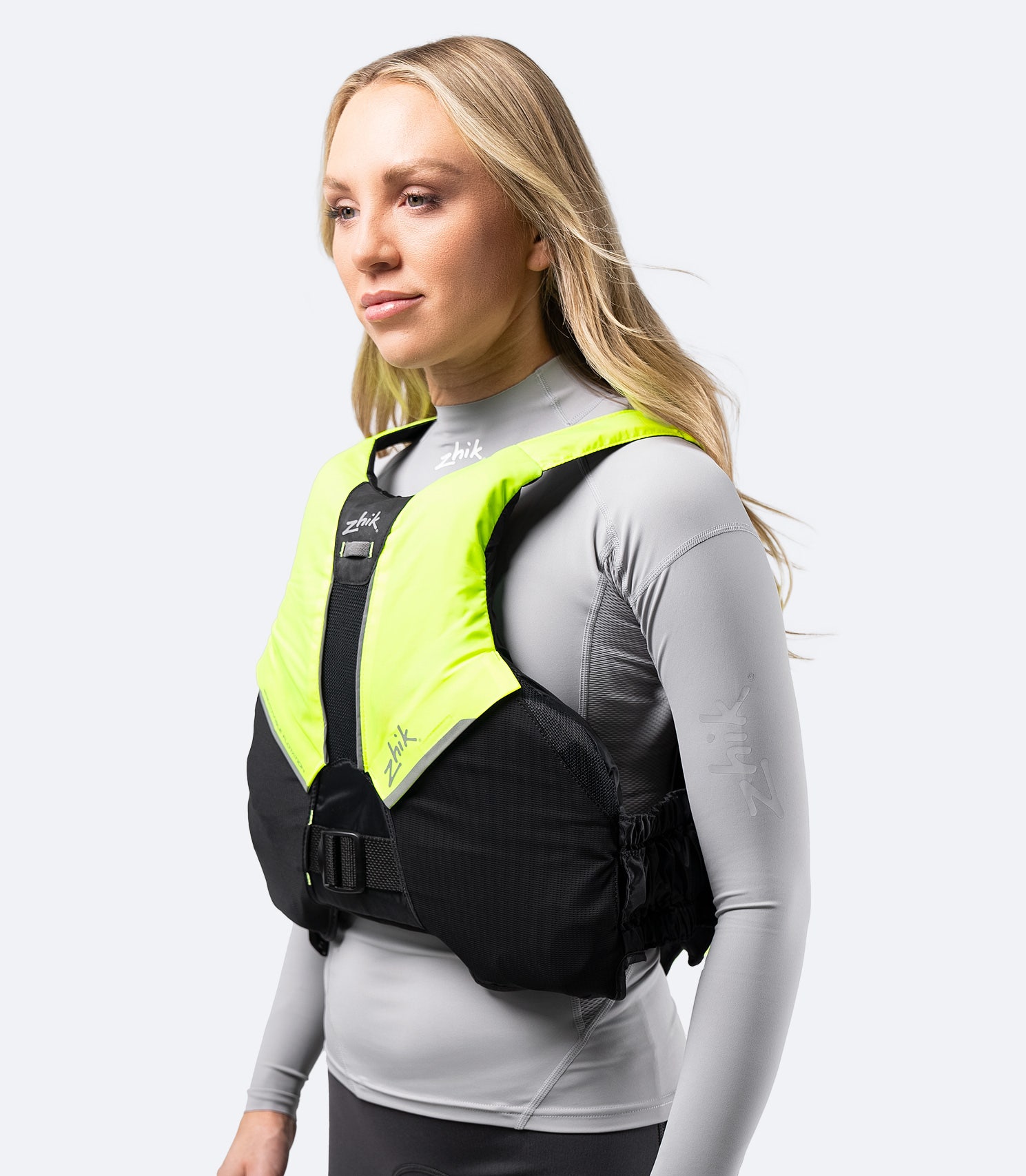 Side view of Zhik Breathable PFD in black and hi-vis yellow, highlighting large armholes for unrestricted movement.