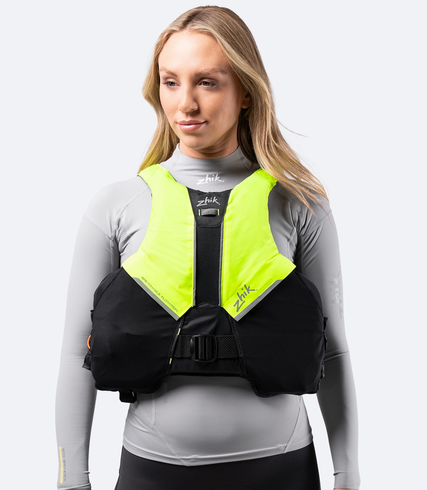 Front view of Zhik Breathable PFD in black and hi-vis yellow, featuring air-permeable mesh pockets and central drinking hose attachment.