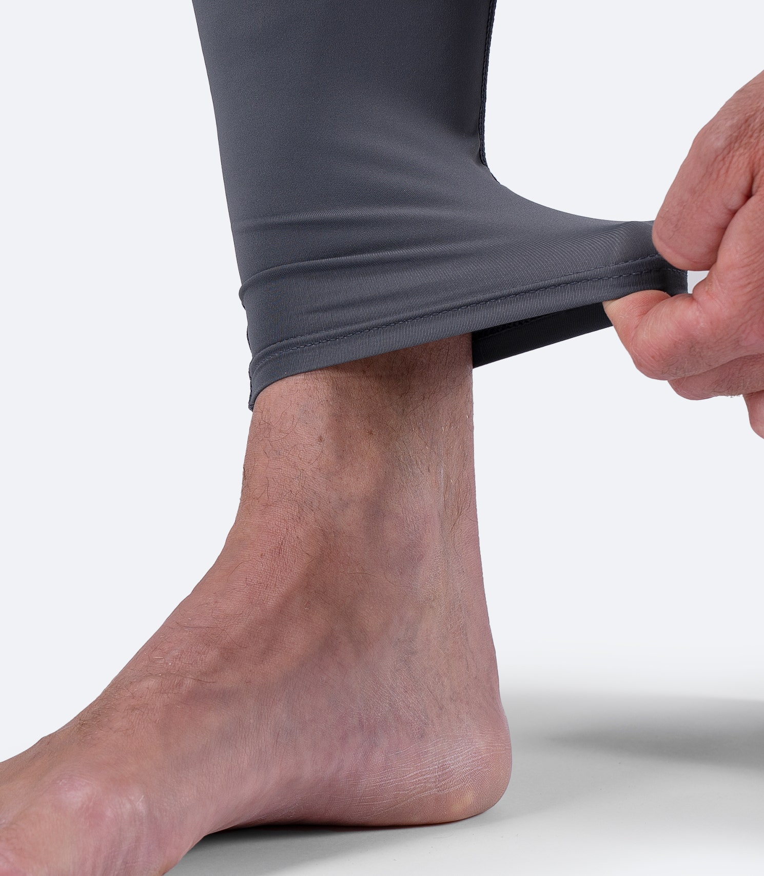 Stretch ankle cuff on Grey Zhik Men’s Hybrid Gear™ Performance Pants for flexible movement.