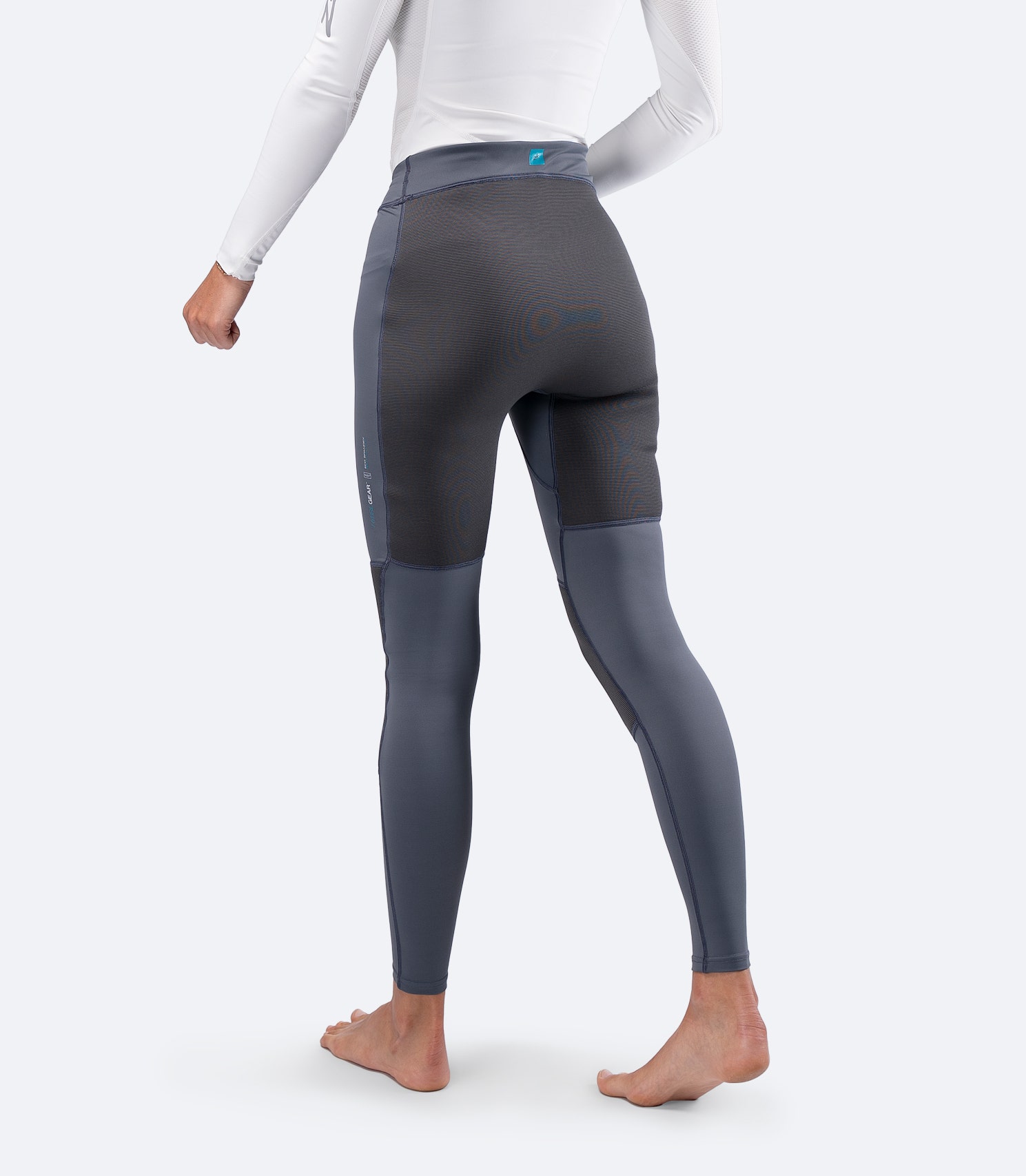 Zhik Women's Hybrid Gear Performance Pants in Grey, angled view highlighting body-mapped fit and durable knee panels.