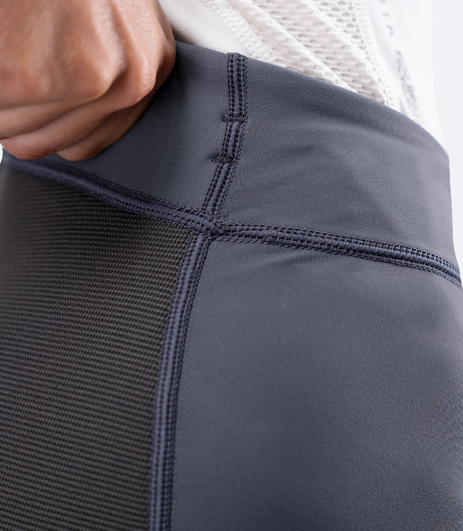 Close-up of Zhik Women's Hybrid Gear Performance Pants in Grey, showing flatlock stitching and high-waist waistband finish.