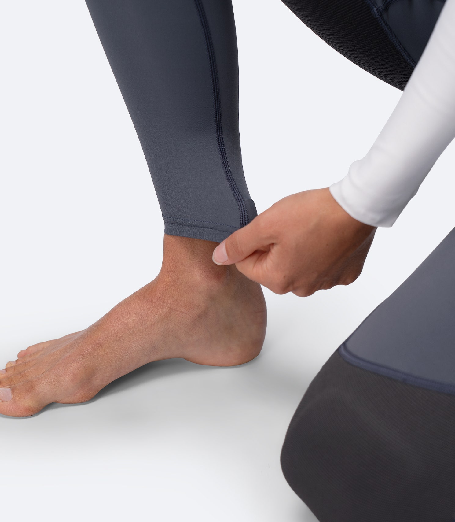 Close-up of Zhik Women's Hybrid Gear Performance Pants in Grey, showing stretch ankle fabric for comfort and easy movement.