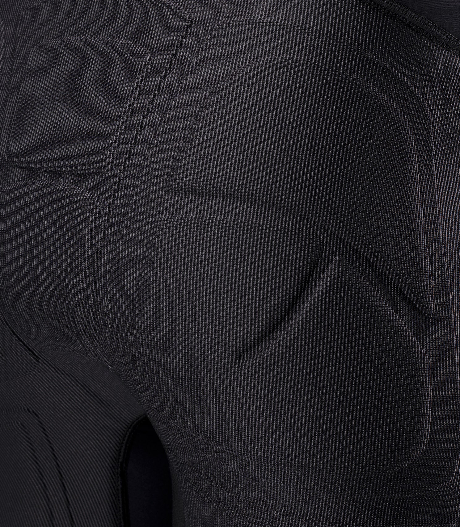 Close-up of Zhik Youth DeckBeater X Short in Black showing compression-molded seat padding for protection from hard deck surfaces
