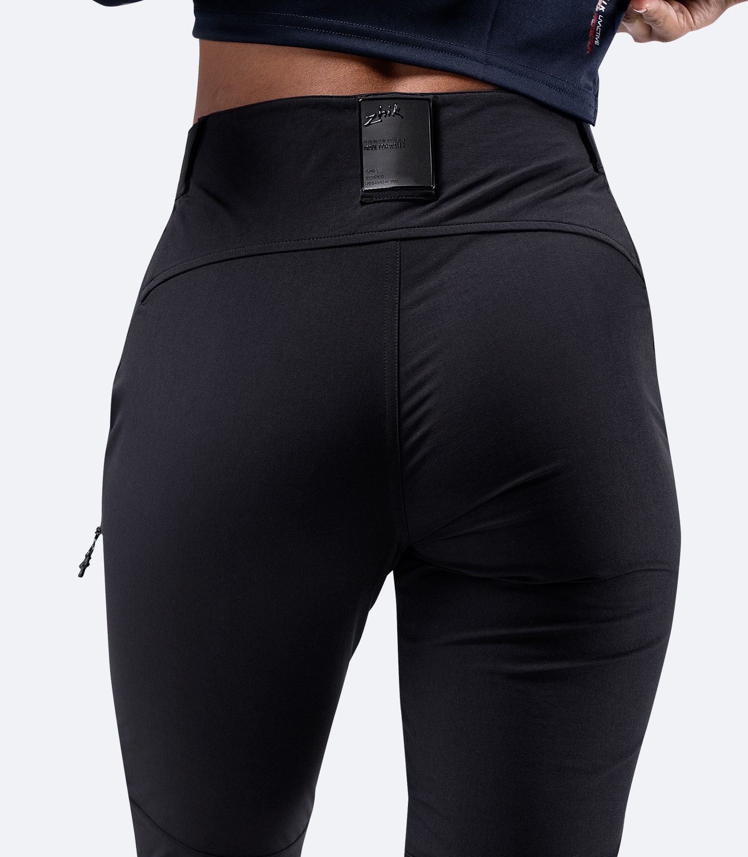 Rear view of Zhik Women's Black Deck Pant, highlighting the semi-elastic waist fit for comfort and the Zhik logo detail