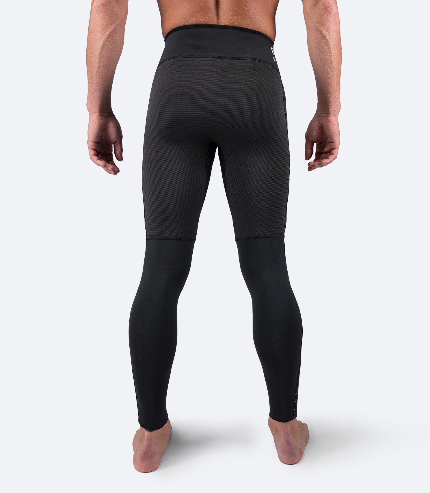 Back view of Zhik Men's Microfleece Pant in black, featuring ergonomic waistband and flatlock seams for added durability and comfort.