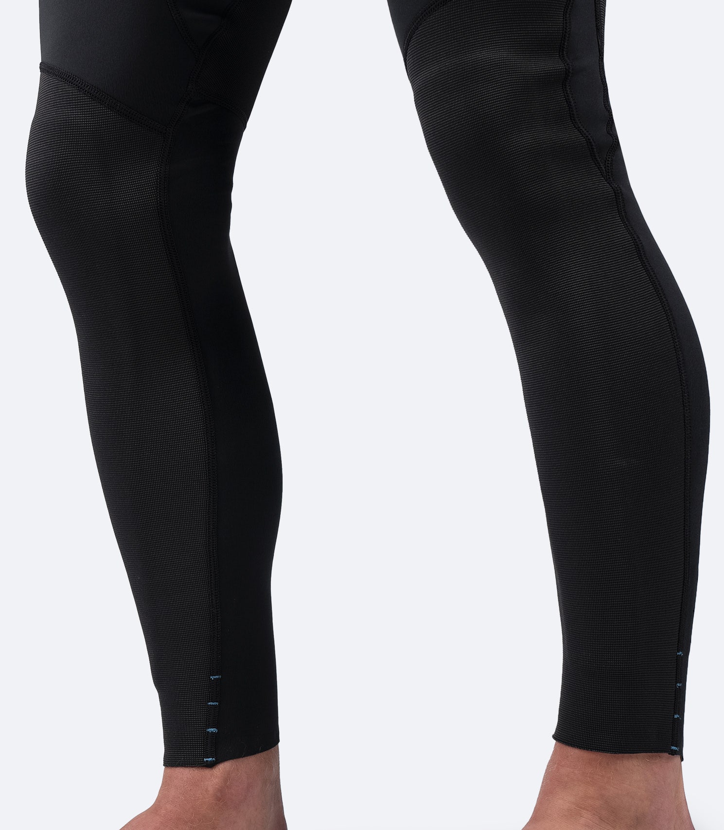 Close-up of Zhik Men's Microfleece Pant ankle area, highlighting drainage holes for quick water expulsion and enhanced comfort