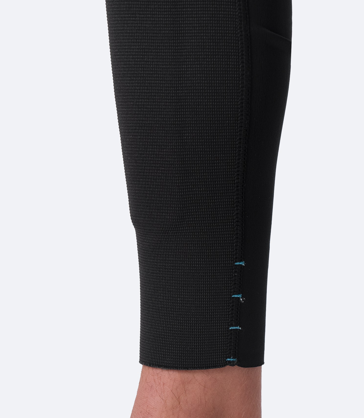 Close-up of Zhik Youth Microfleece Pant ankle with drainage holes to expel trapped water and adjustable leg length for a custom fit