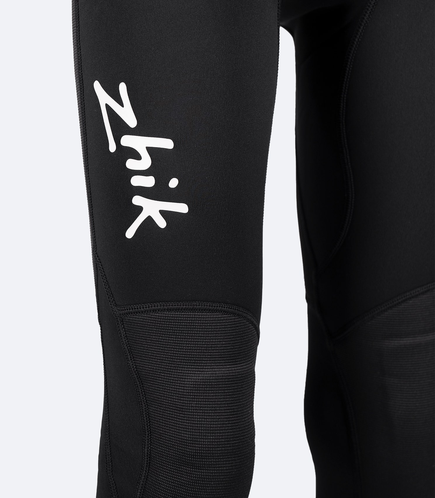Close-up of flatlock seam construction and stress point tape on Zhik Youth Microfleece Pant, designed for durability and performance