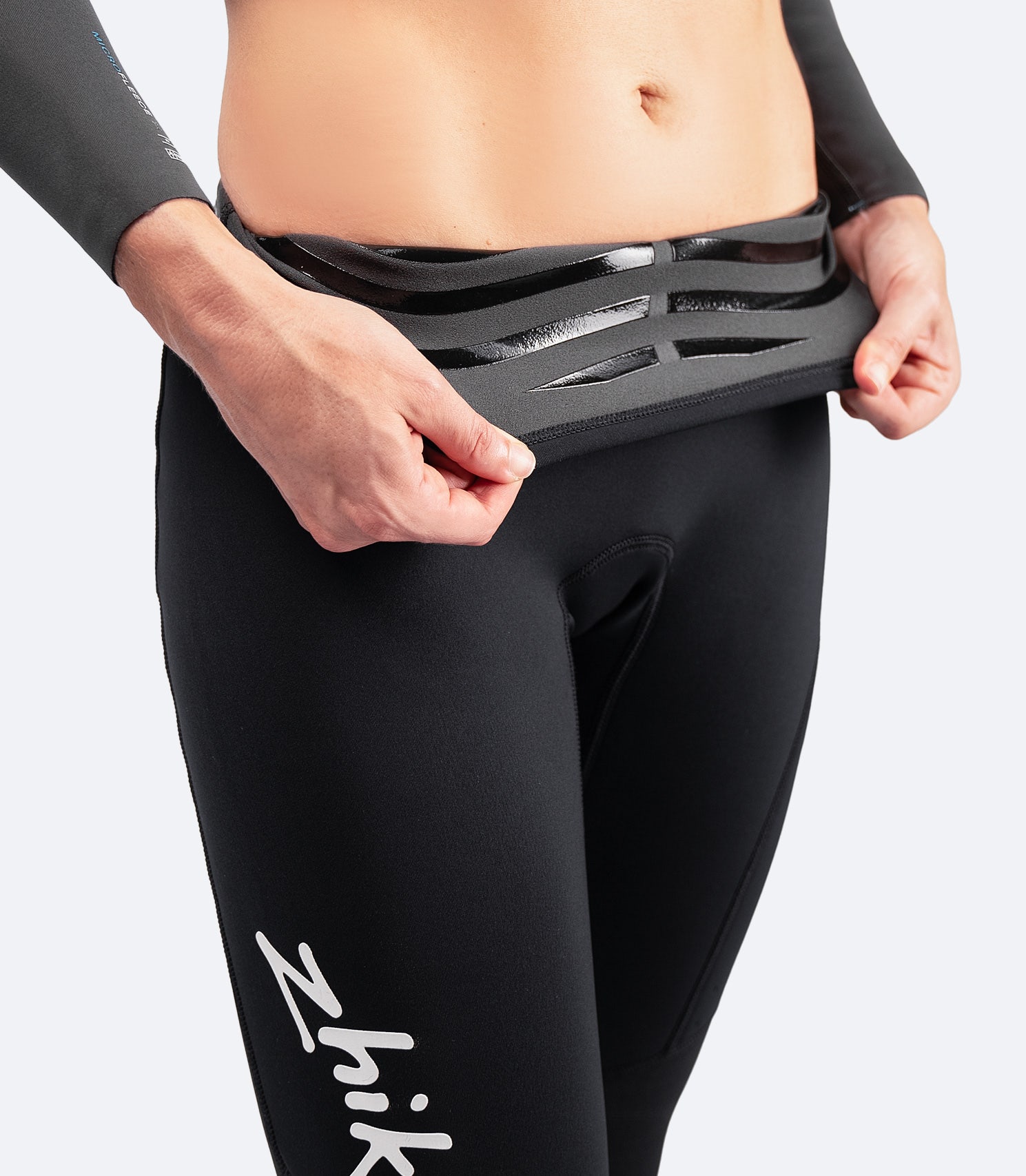 Close-up of Zhik Women's MicrofleeceX Pants showing interior silicone waist grip for secure fit and comfort during sailing.