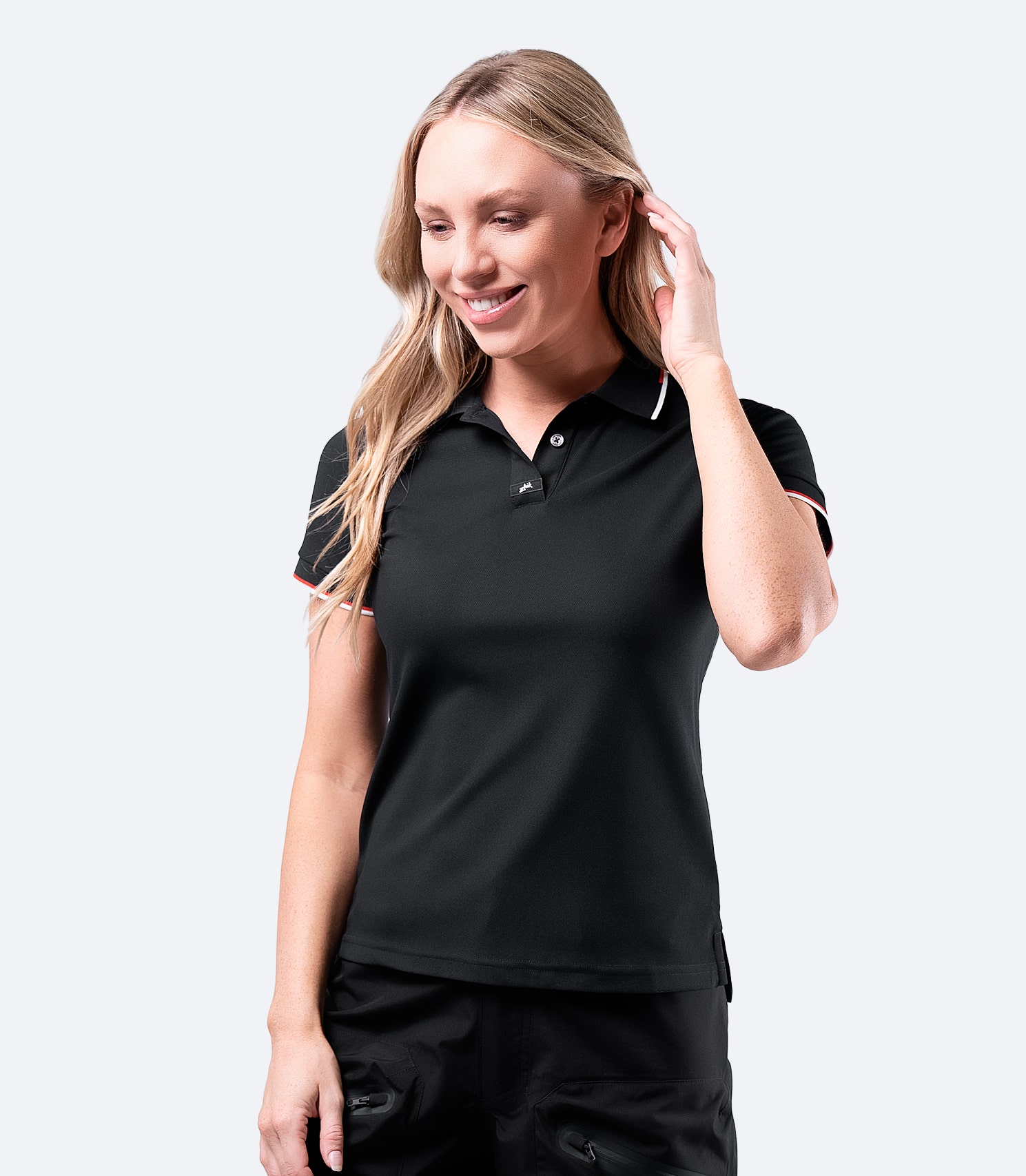 Zhik Women's Elite Polo in Black, featuring a contrast collar and arm trim, made for active performance.