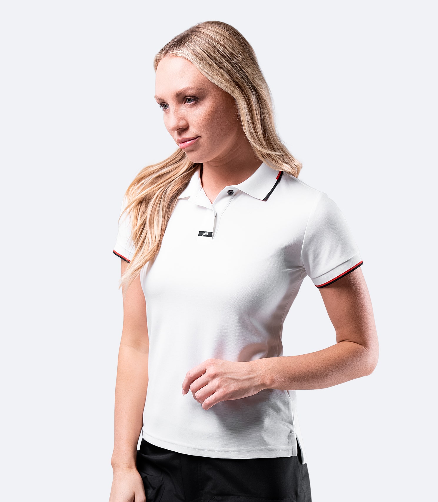Side profile of Zhik Women's Elite Polo in White, highlighting the ergonomic fit and lightweight fabric.