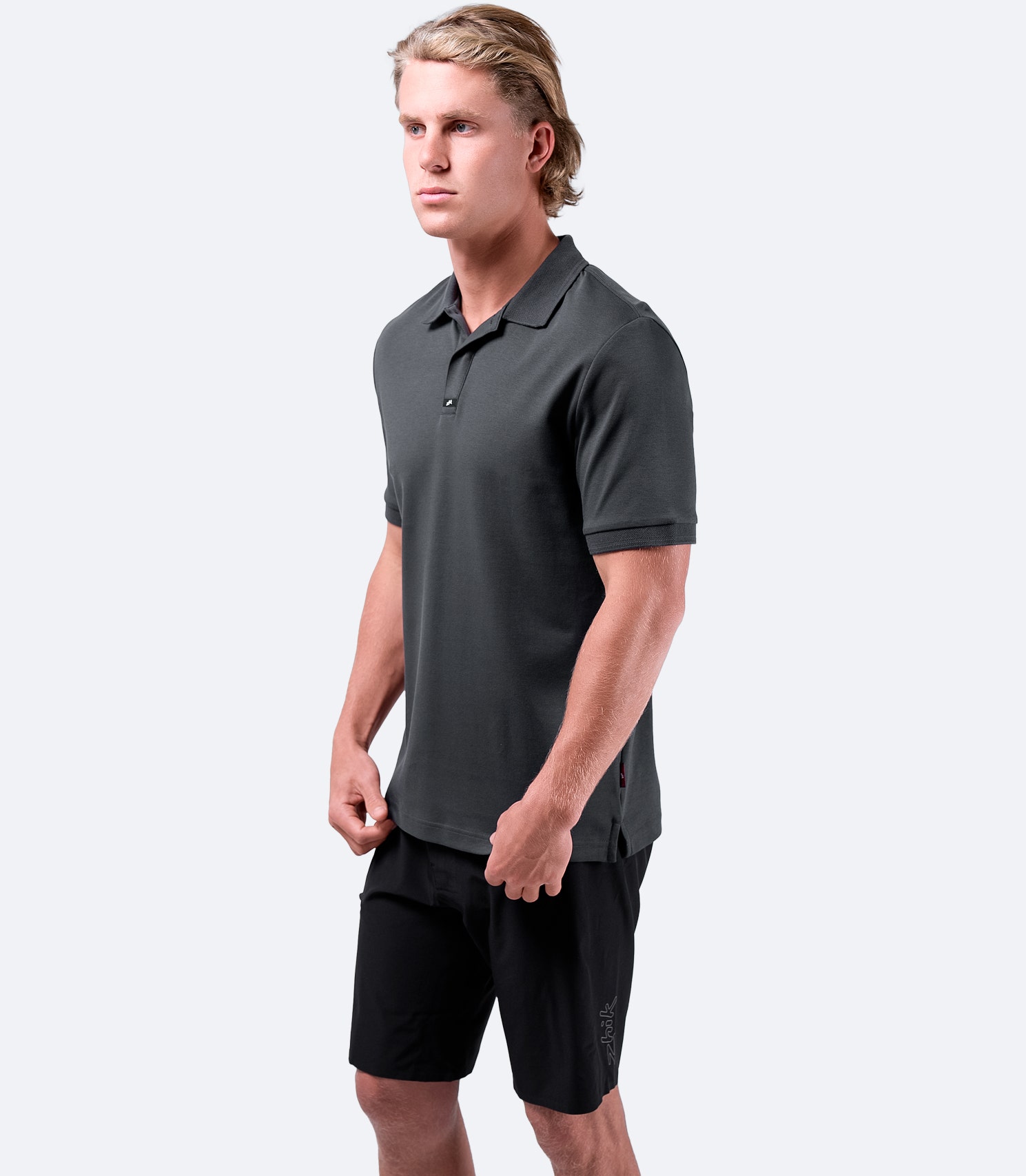 Side view of Zhik Men's Pima Cotton Polo in charcoal, highlighting the refined styling and soft, natural cotton.