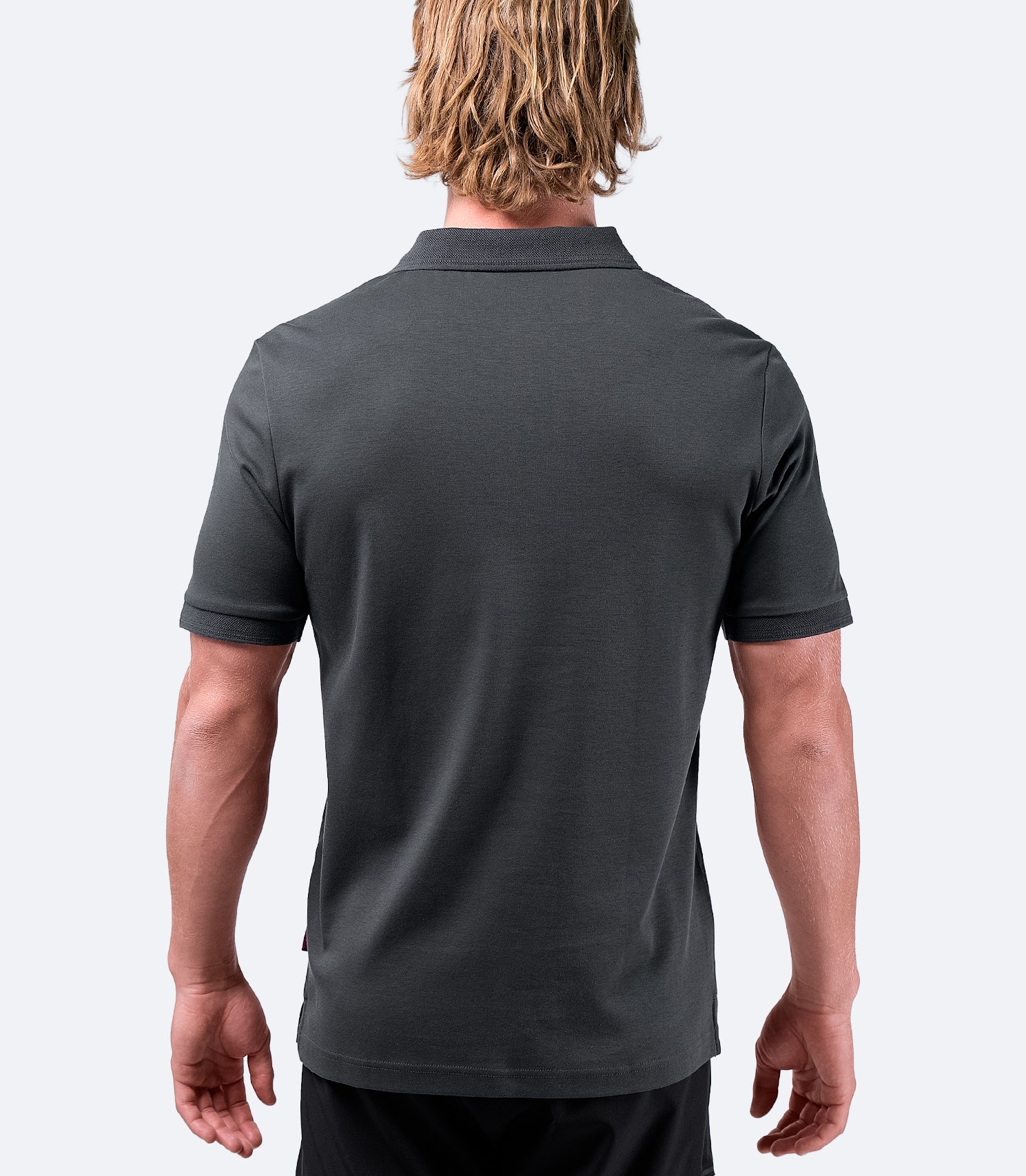 Zhik Men's Pima Cotton Polo in charcoal, back view, with a refined fit and lightweight, breathable construction.