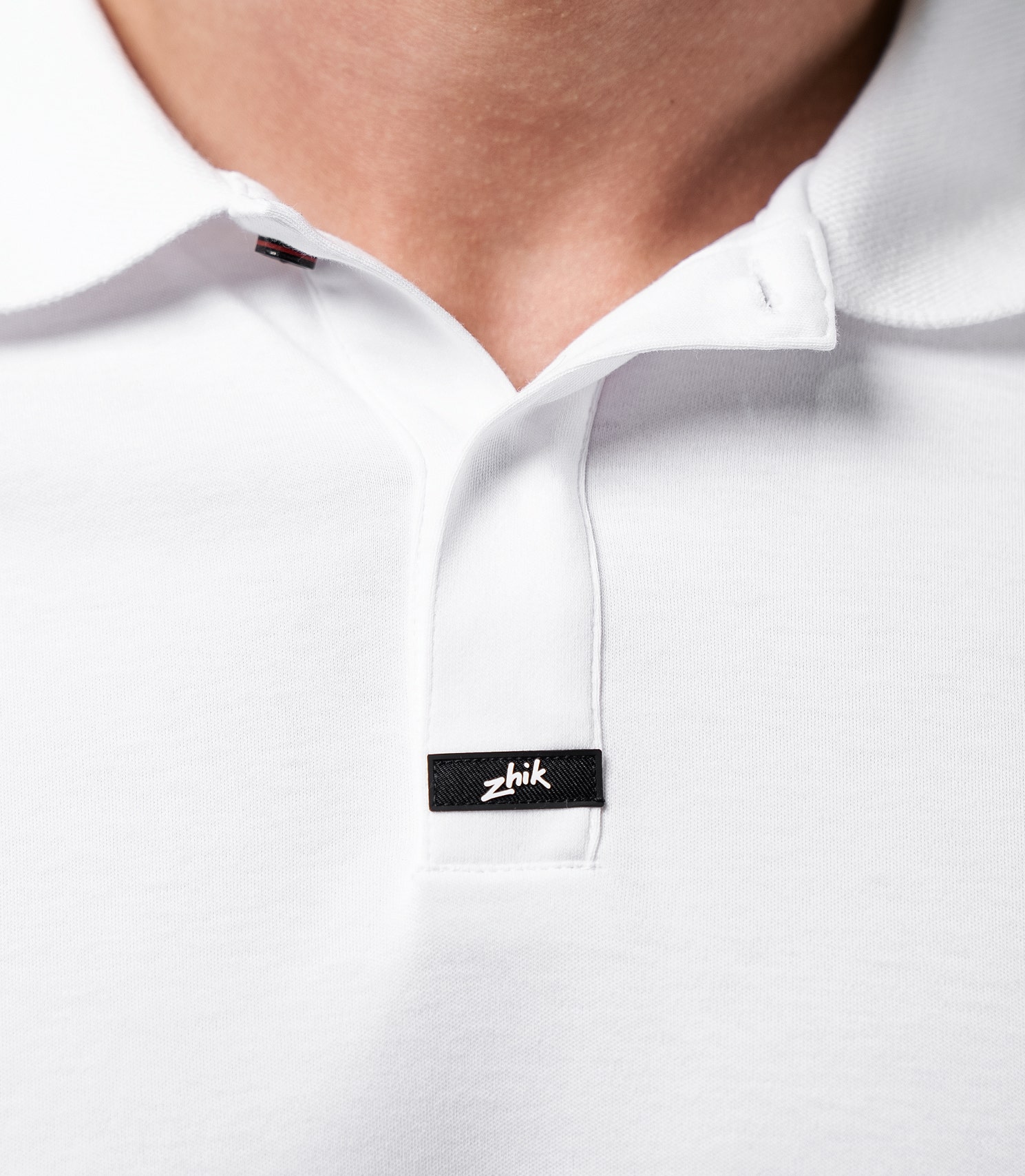 Zhik Men's Pima Cotton Polo in white, close-up of the collar and soft, breathable Supima cotton texture.